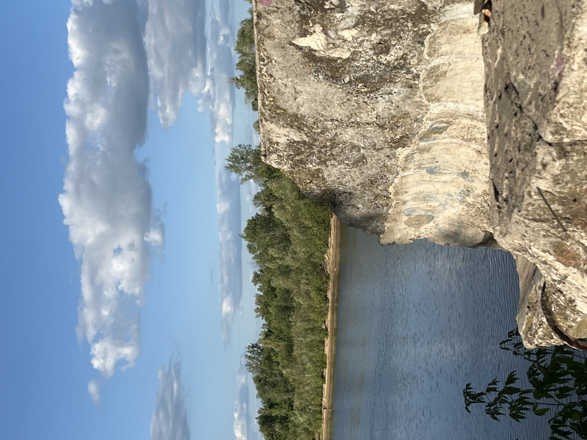 Pripyat riverbank in Narowlya: calm water, weathered Soviet monument