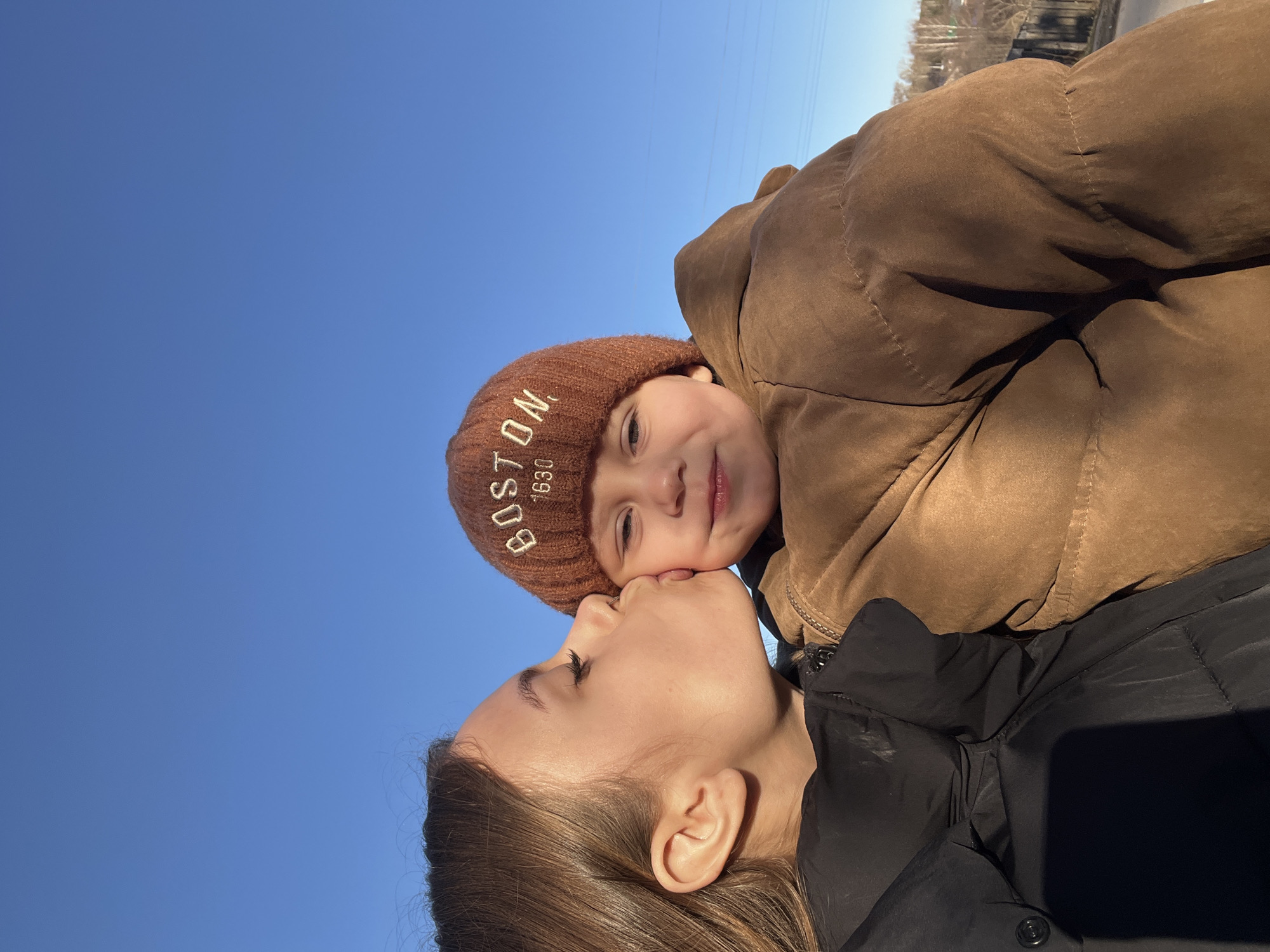 Mother and child enjoy outdoor playtime in Russian village