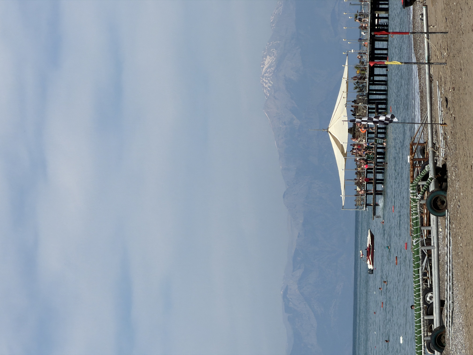 Crowded pier draws visitors in Serik, Turkey coastal scene