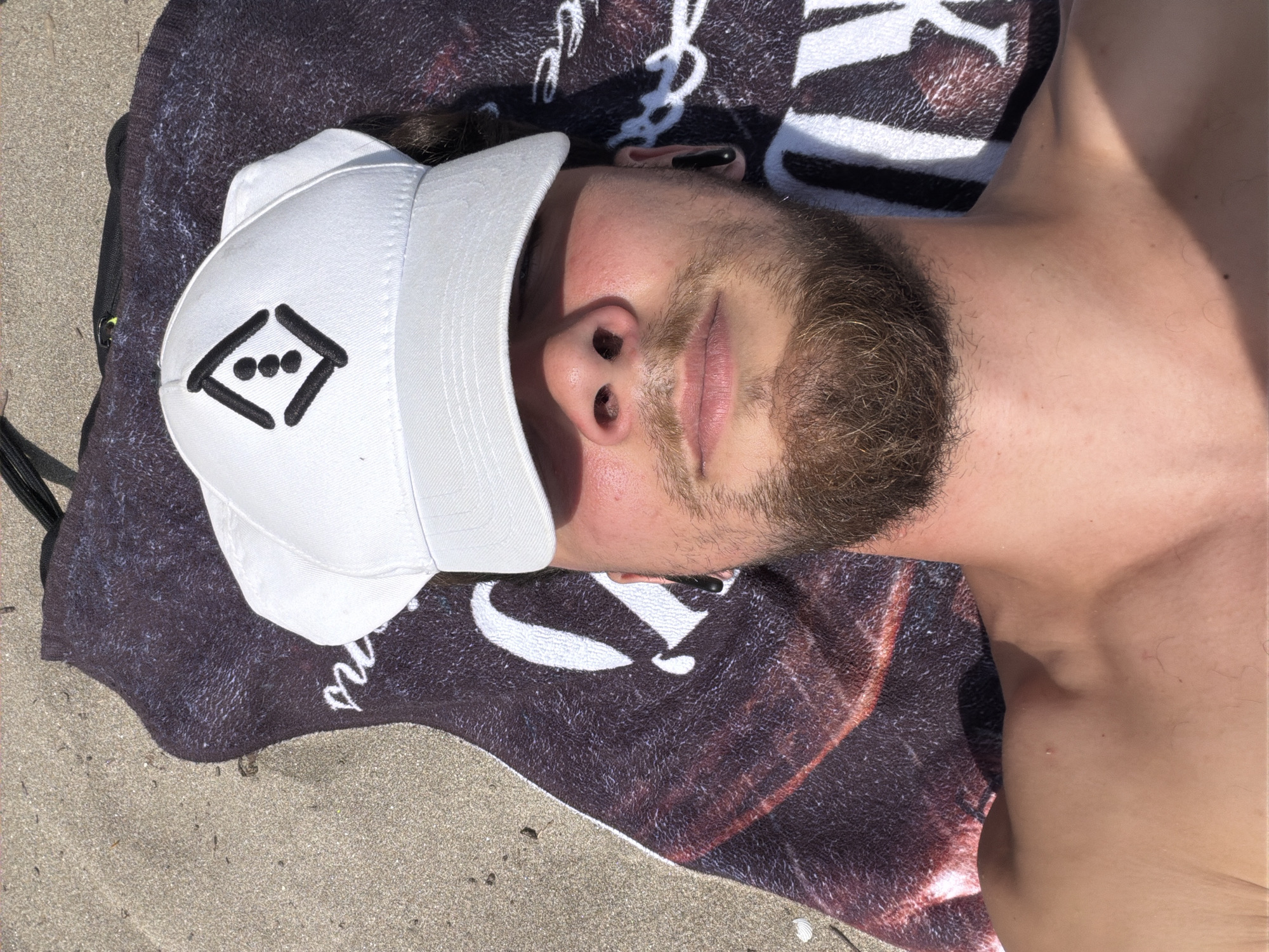 Man rests on beach in Tsarevo, Bulgaria