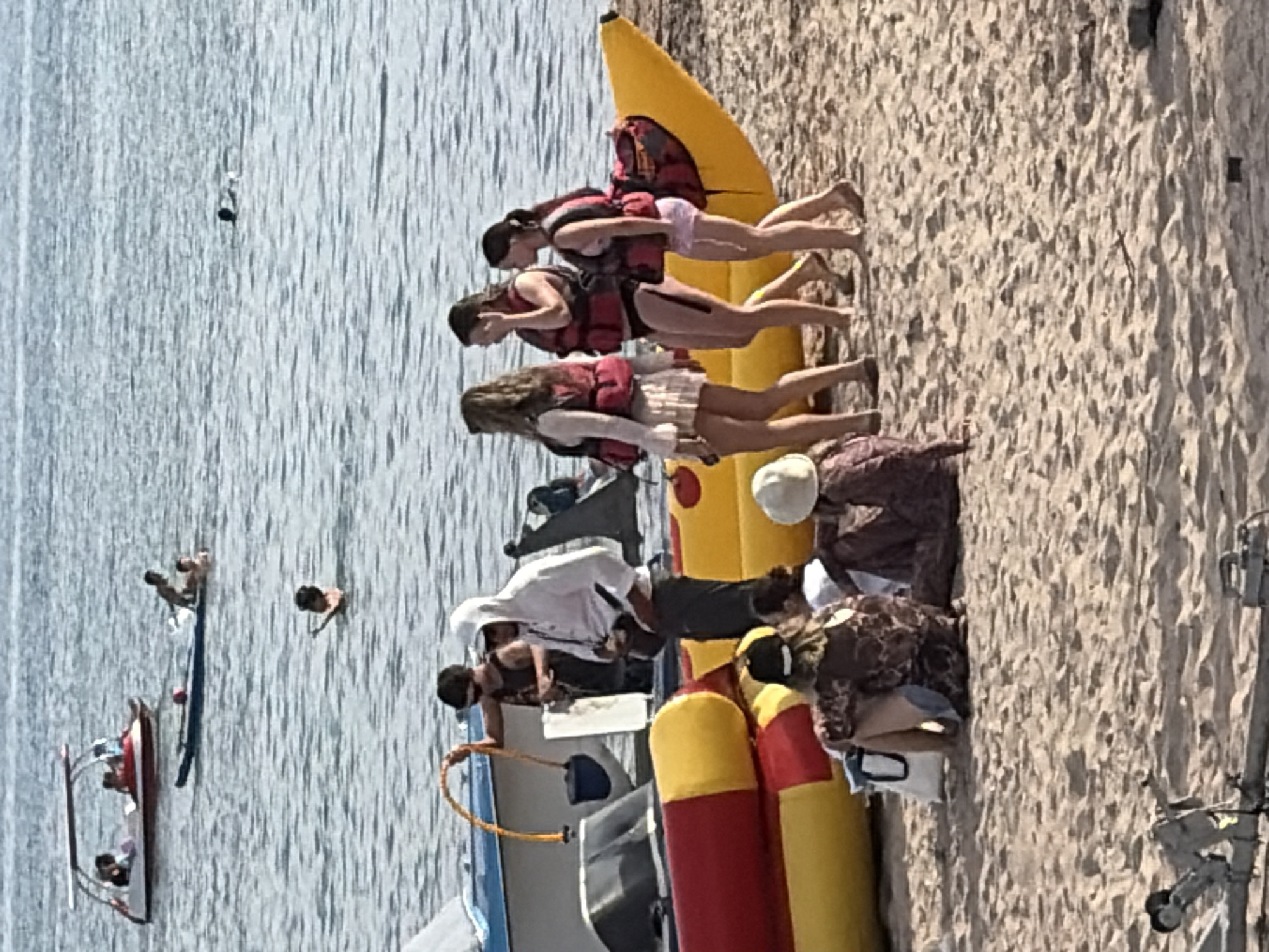 Full day of watersports and beach activity at a busy coastal spot