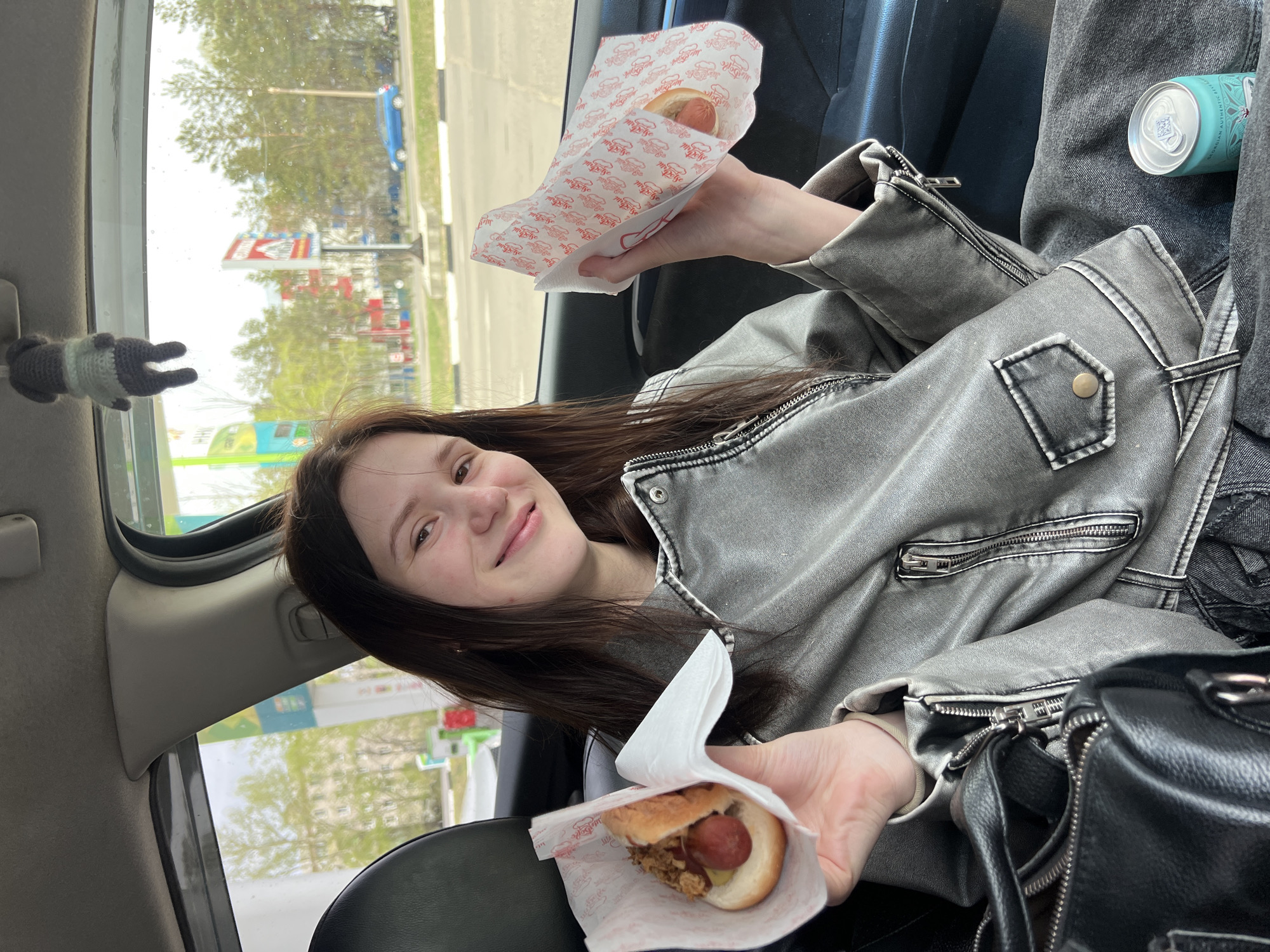Two women share late-night hot dogs in car