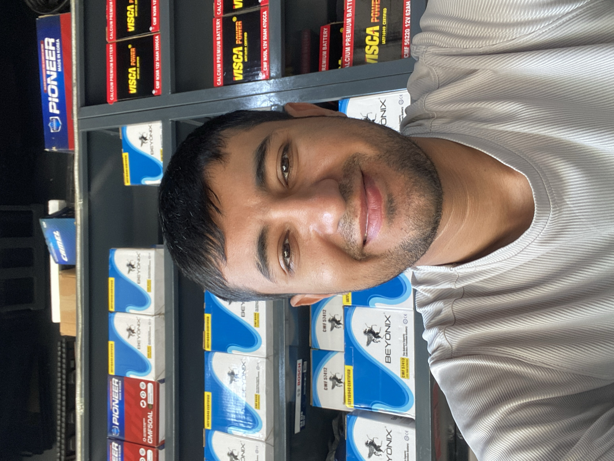 Man photographed at car battery shop in Bukhara