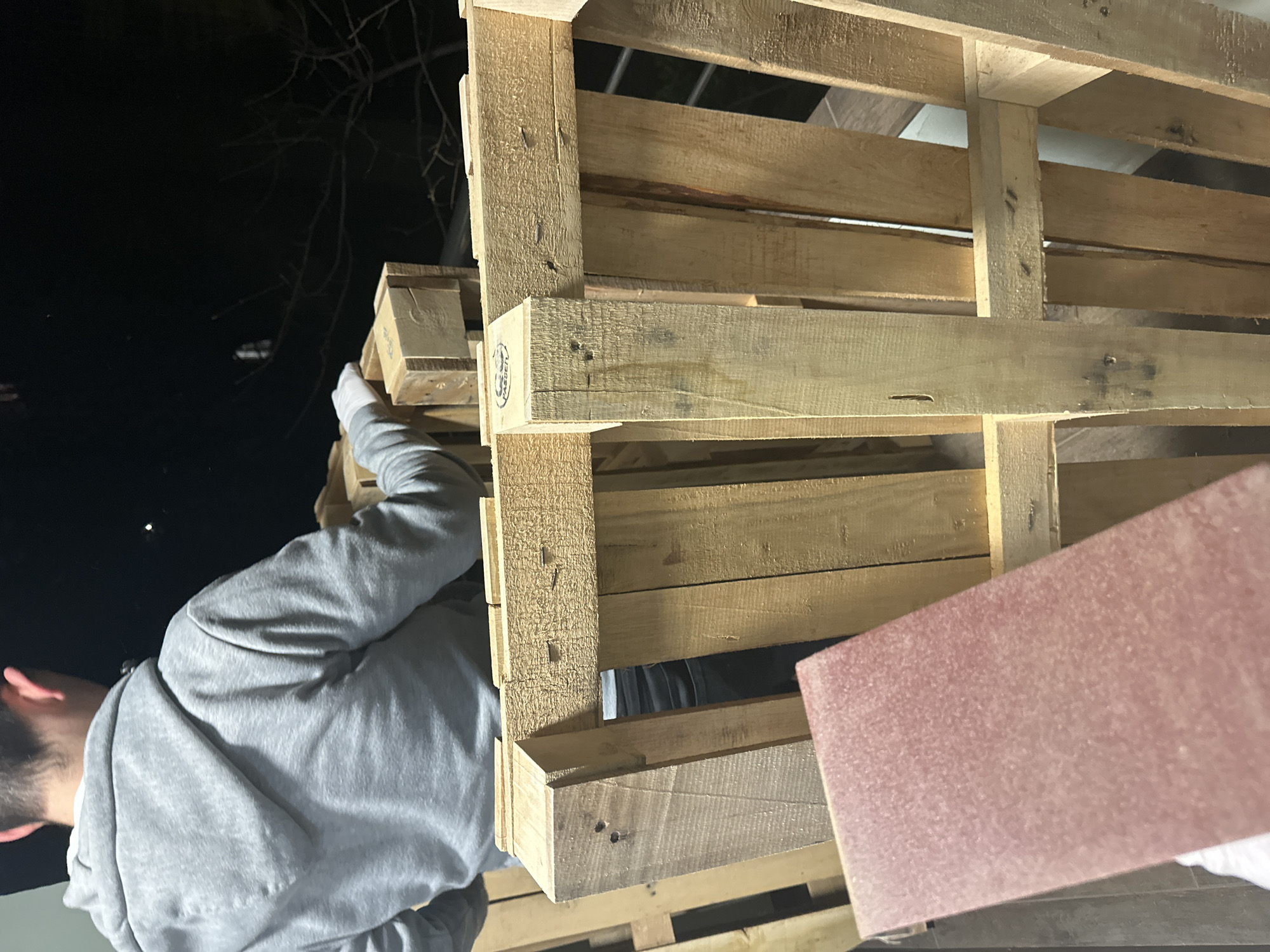 Man works with wood pallets outdoors in Sofia