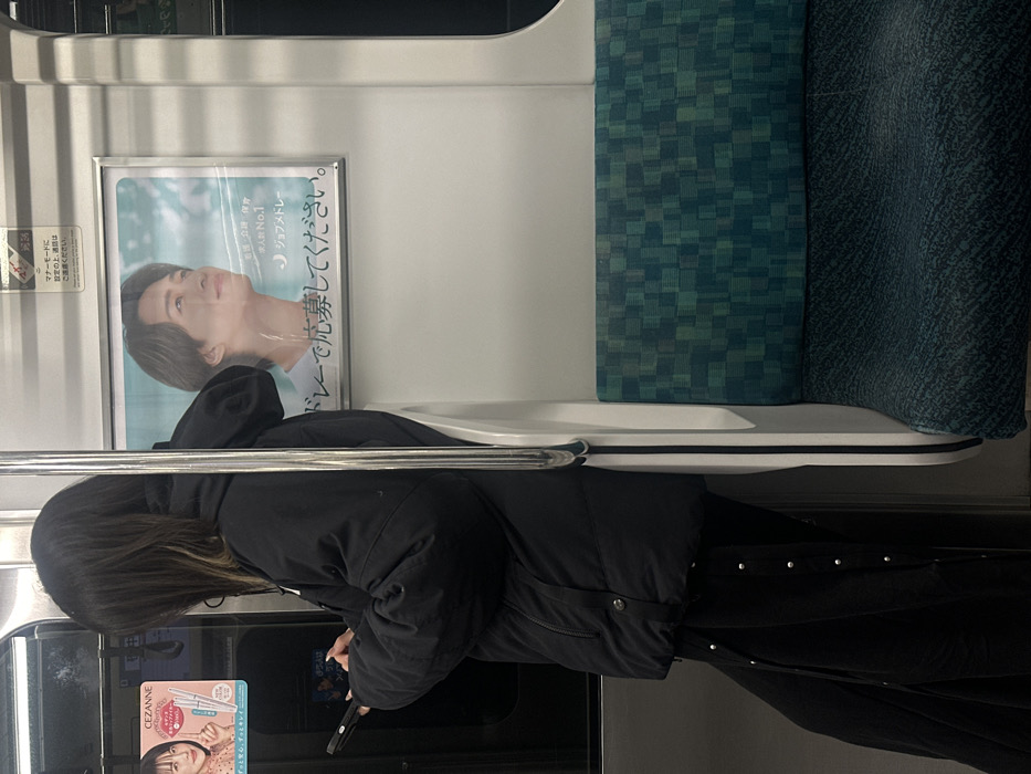 Solitary commuter rides train in Nakano, Japan