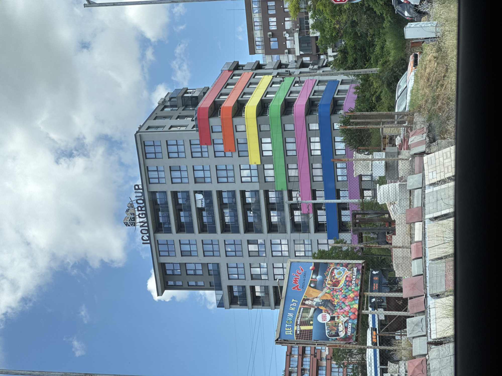 Varna's colorful ICON GROUP tower and an abandoned car nearby