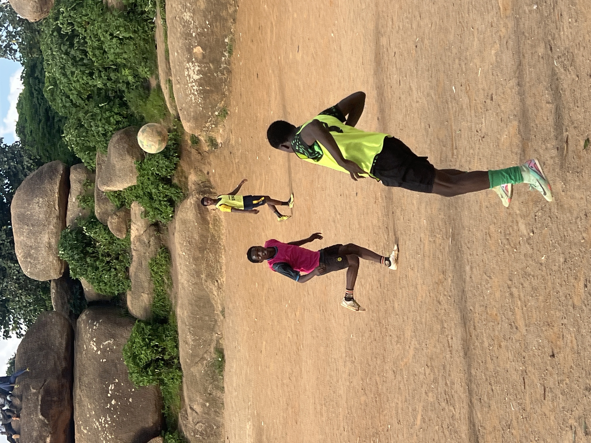 Pickup soccer on a rocky dirt field in Jos, Nigeria