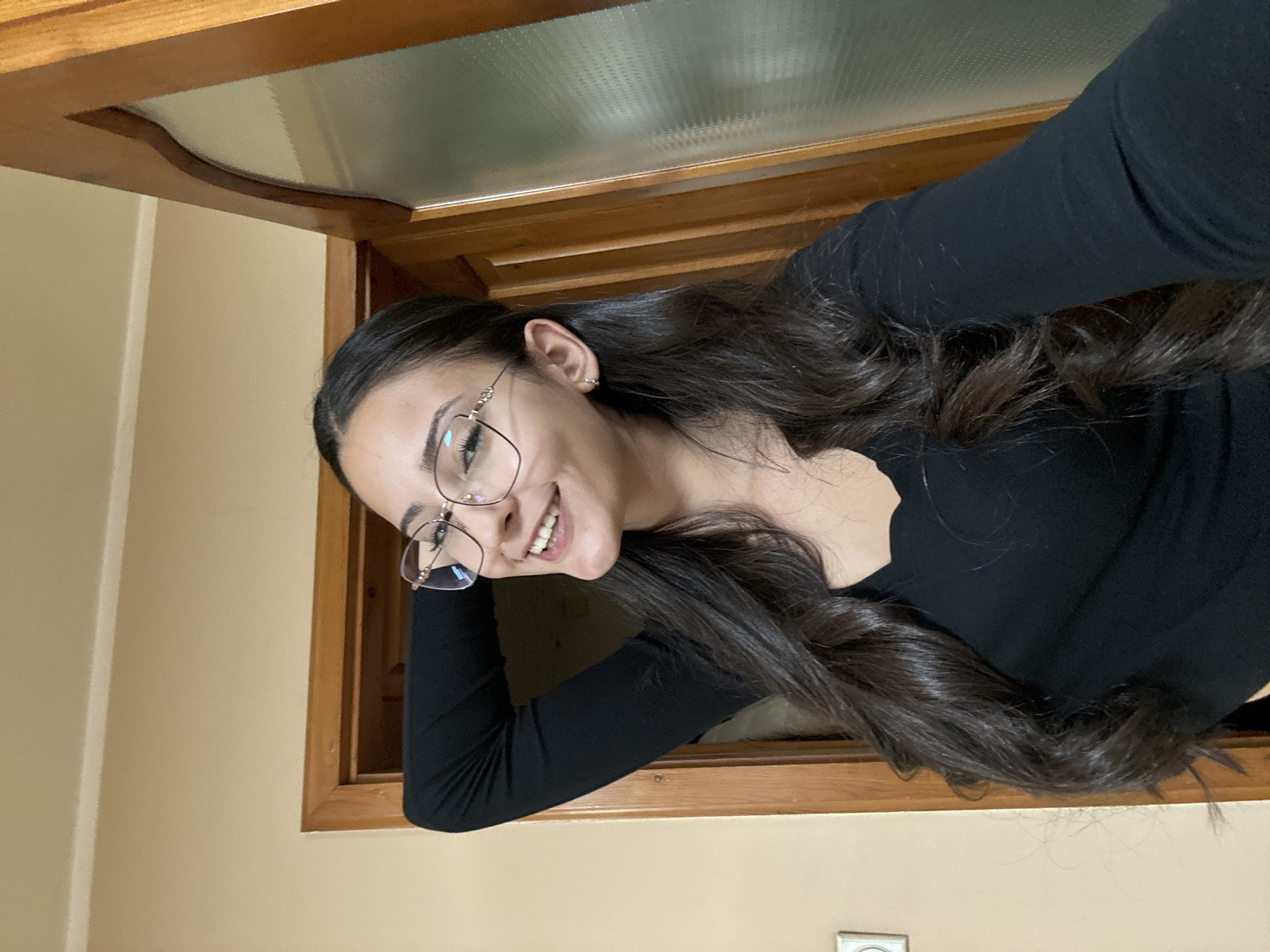 Woman poses for portrait at wooden doorway in Dupnitsa
