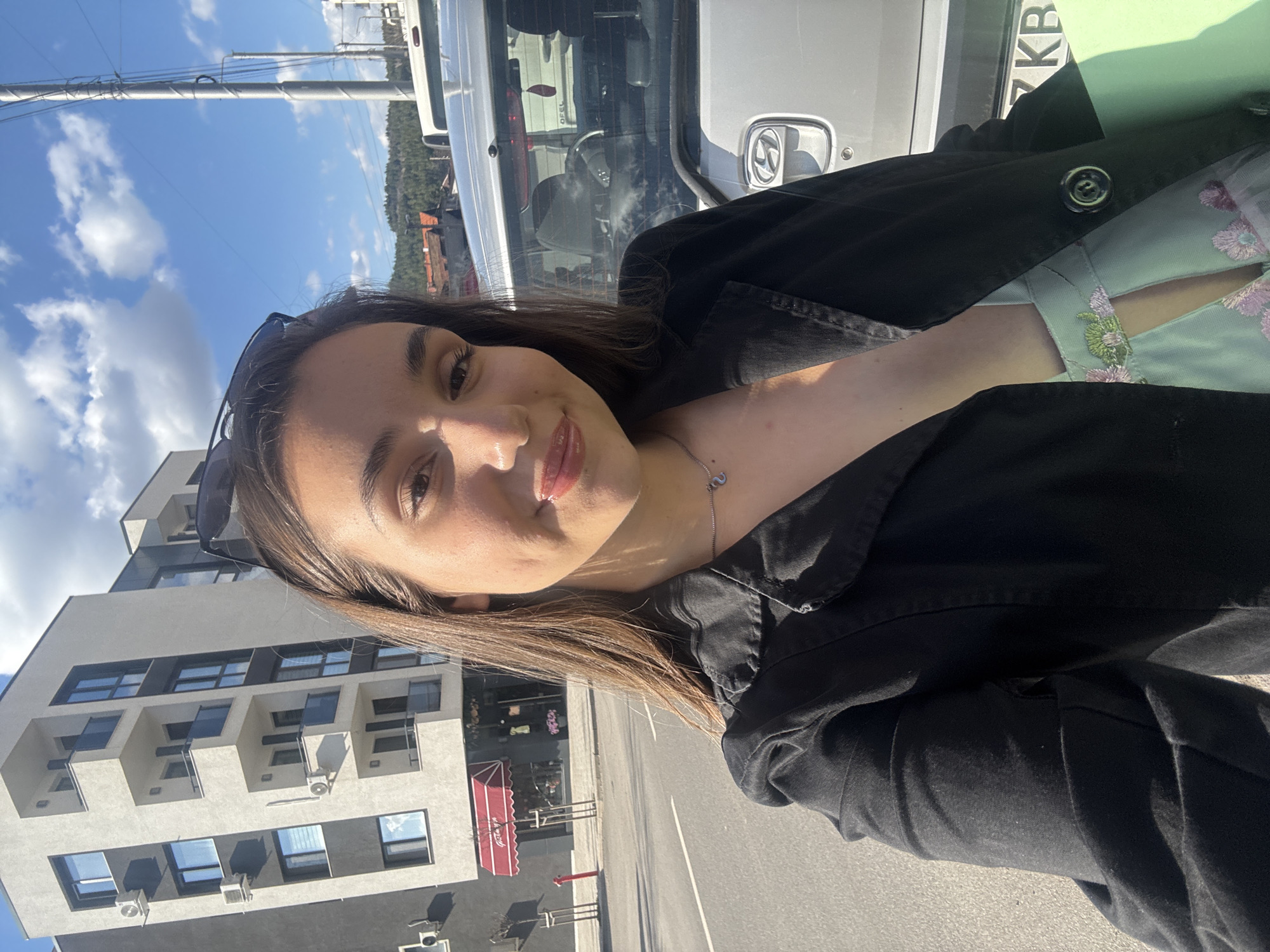 Woman takes sunny day selfie in Pernik, Bulgaria