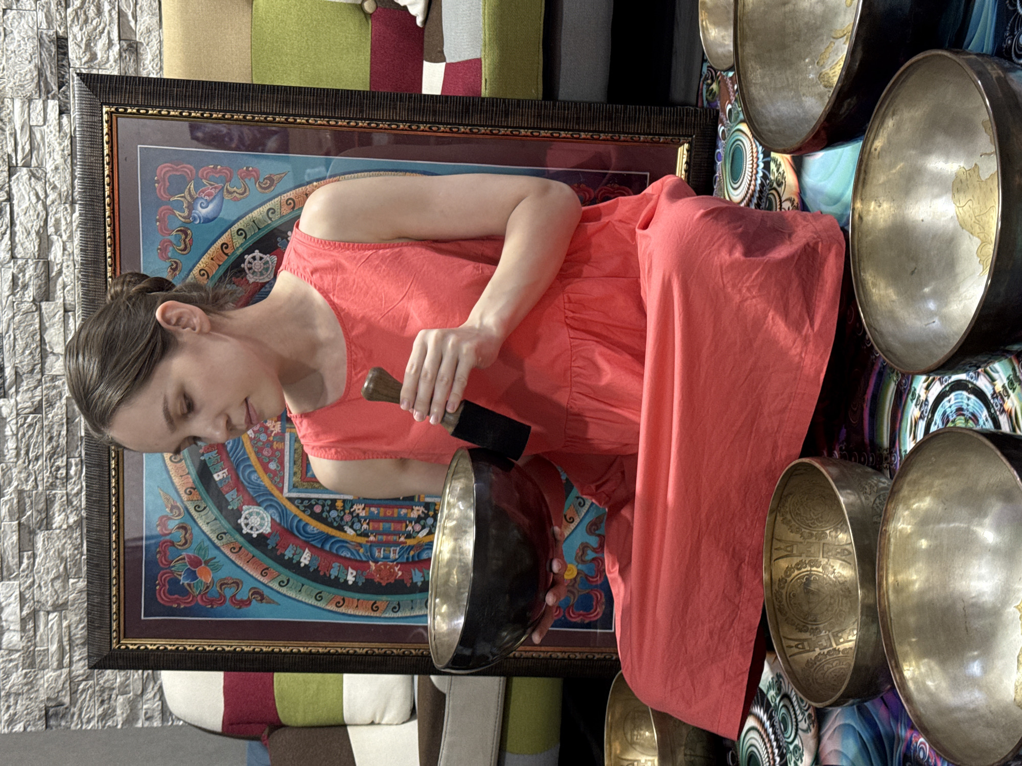 Woman plays singing bowls in Tashkent musical session