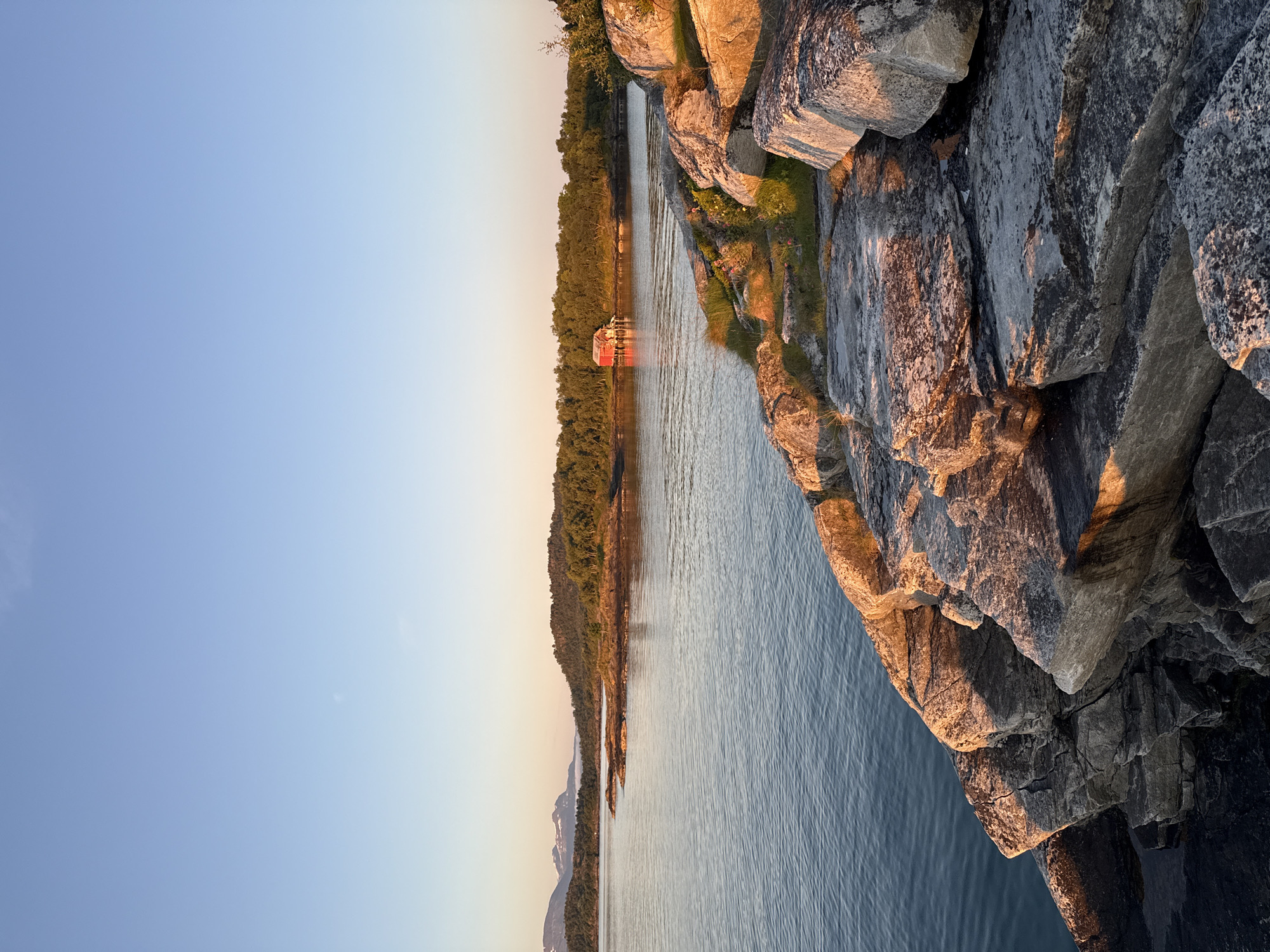 Golden hour along the fjord shoreline in Harstad, Norway