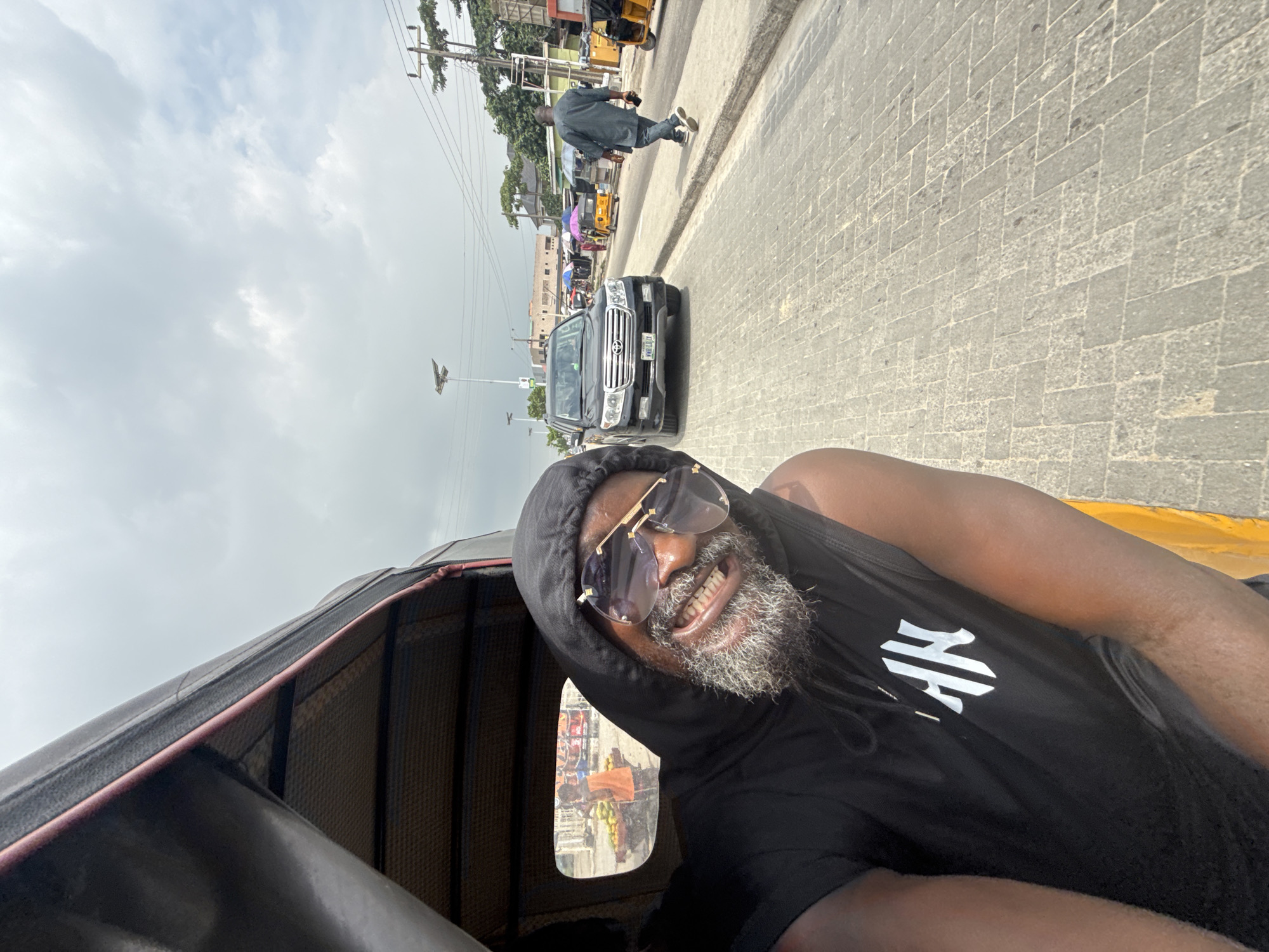 Man Takes Selfie While Riding Rickshaw in Ado
