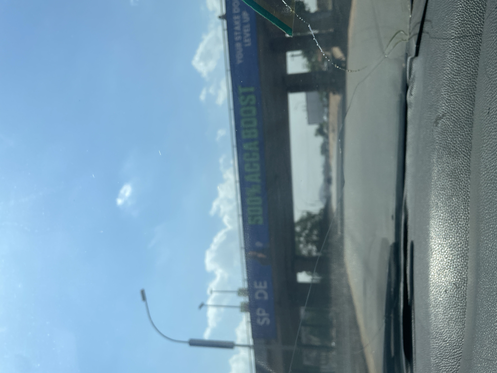 Vehicle occupant documents sky views through windshield in Abuja