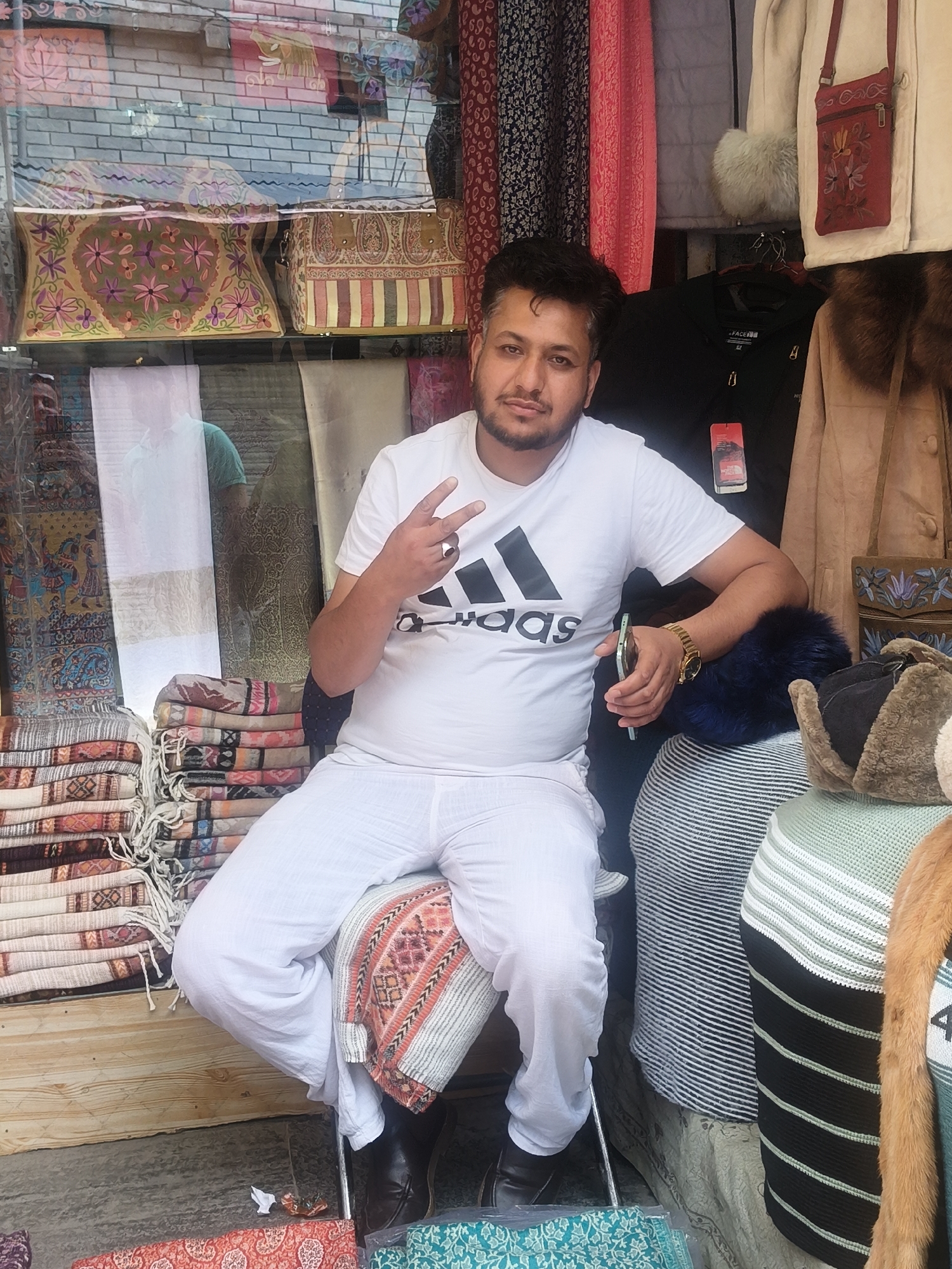 Outdoor market stalls in Vashisht selling clothes, accessories, and jewelry