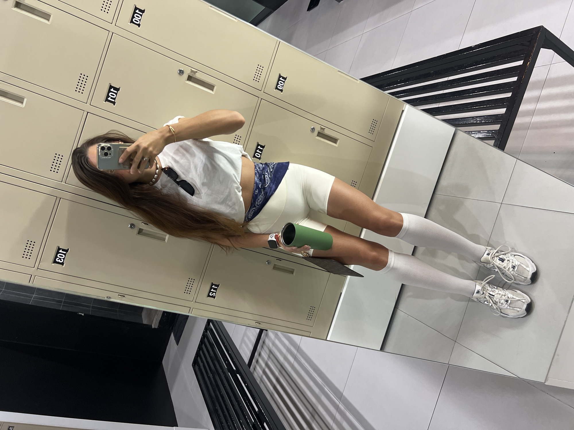 All-white gym outfit mirror selfie, locker room setting