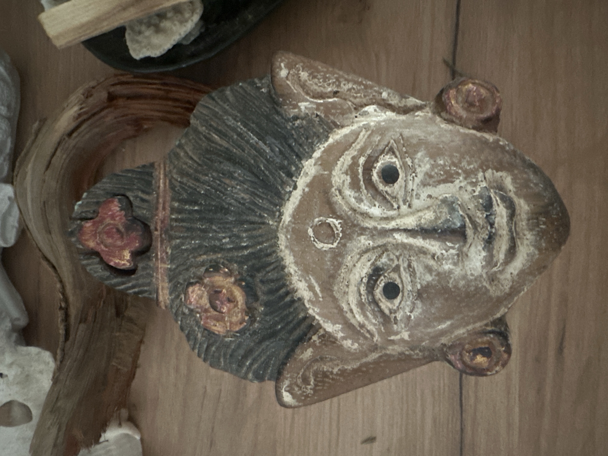 Ceremonial wooden mask and Buddha statue on display in Russia