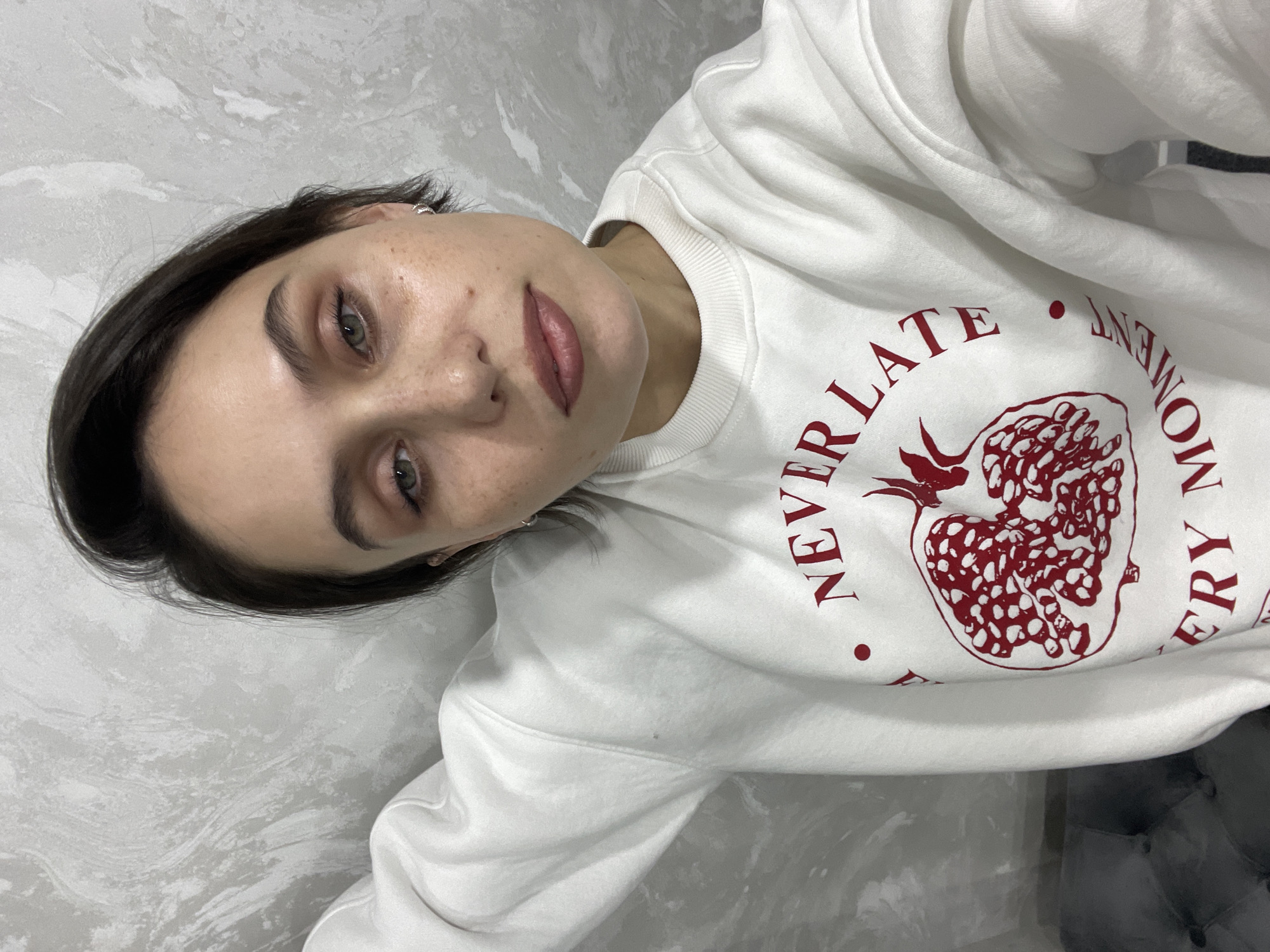 Young girl makes heart gesture in Izhevsk bedroom