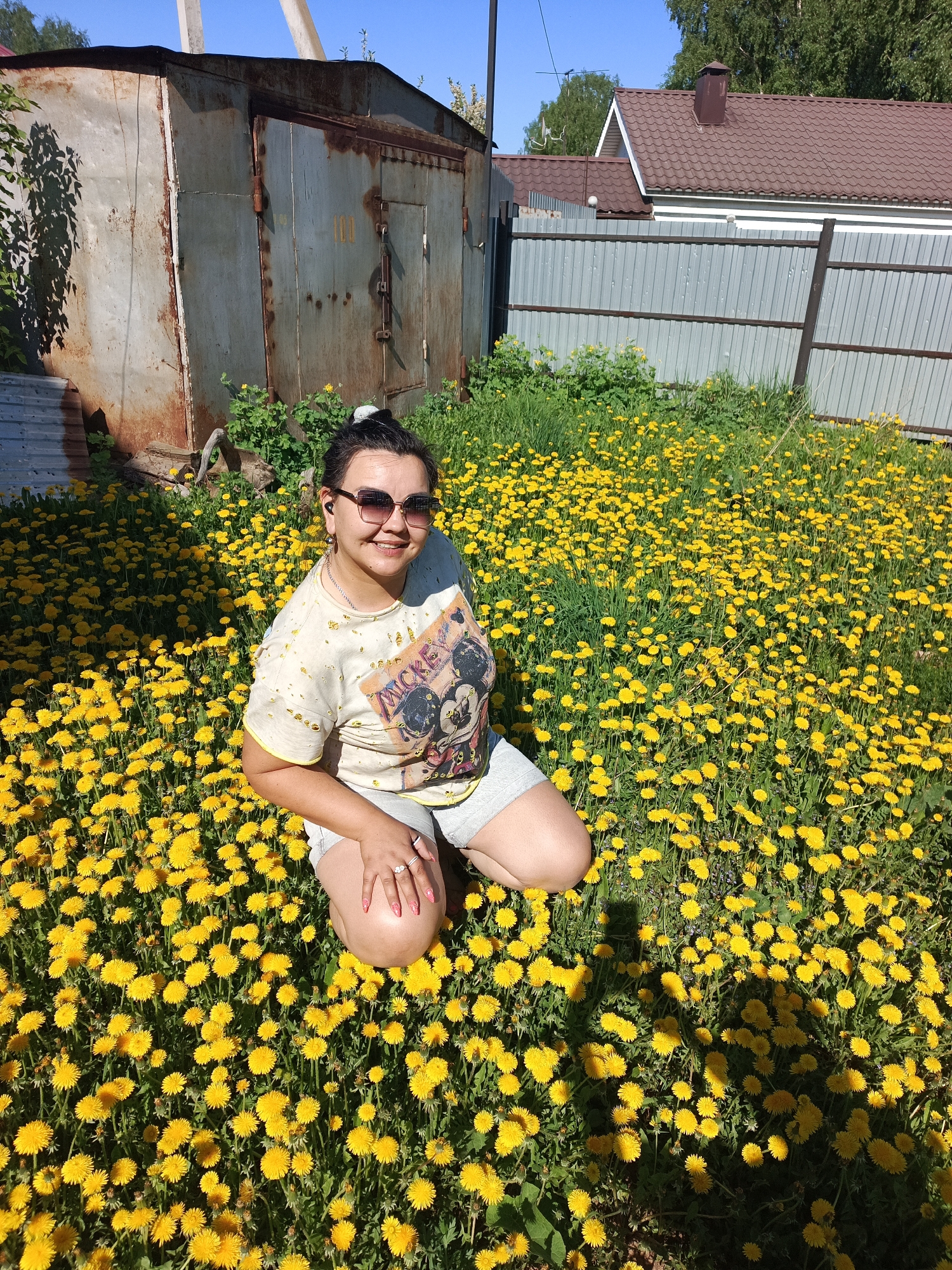 Woman photographed in blooming dandelion field in Chaikovsky, Russia