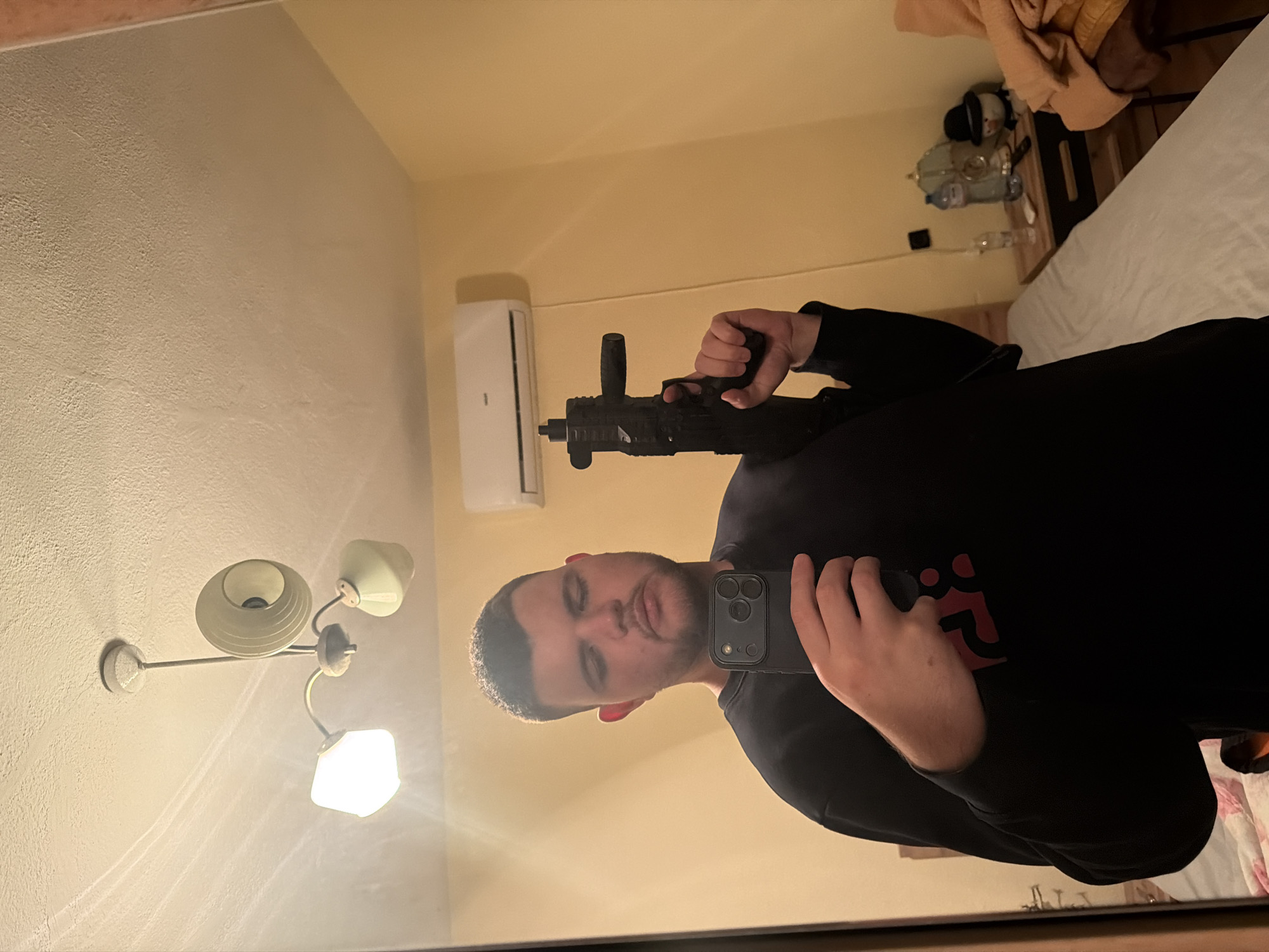 Man Takes Mirror Selfie While Holding Apparent Firearm