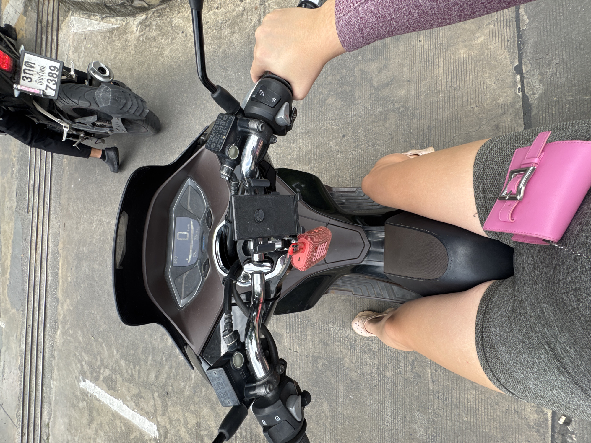Helmeted riders stopped along a street in Nong Pa Khrang
