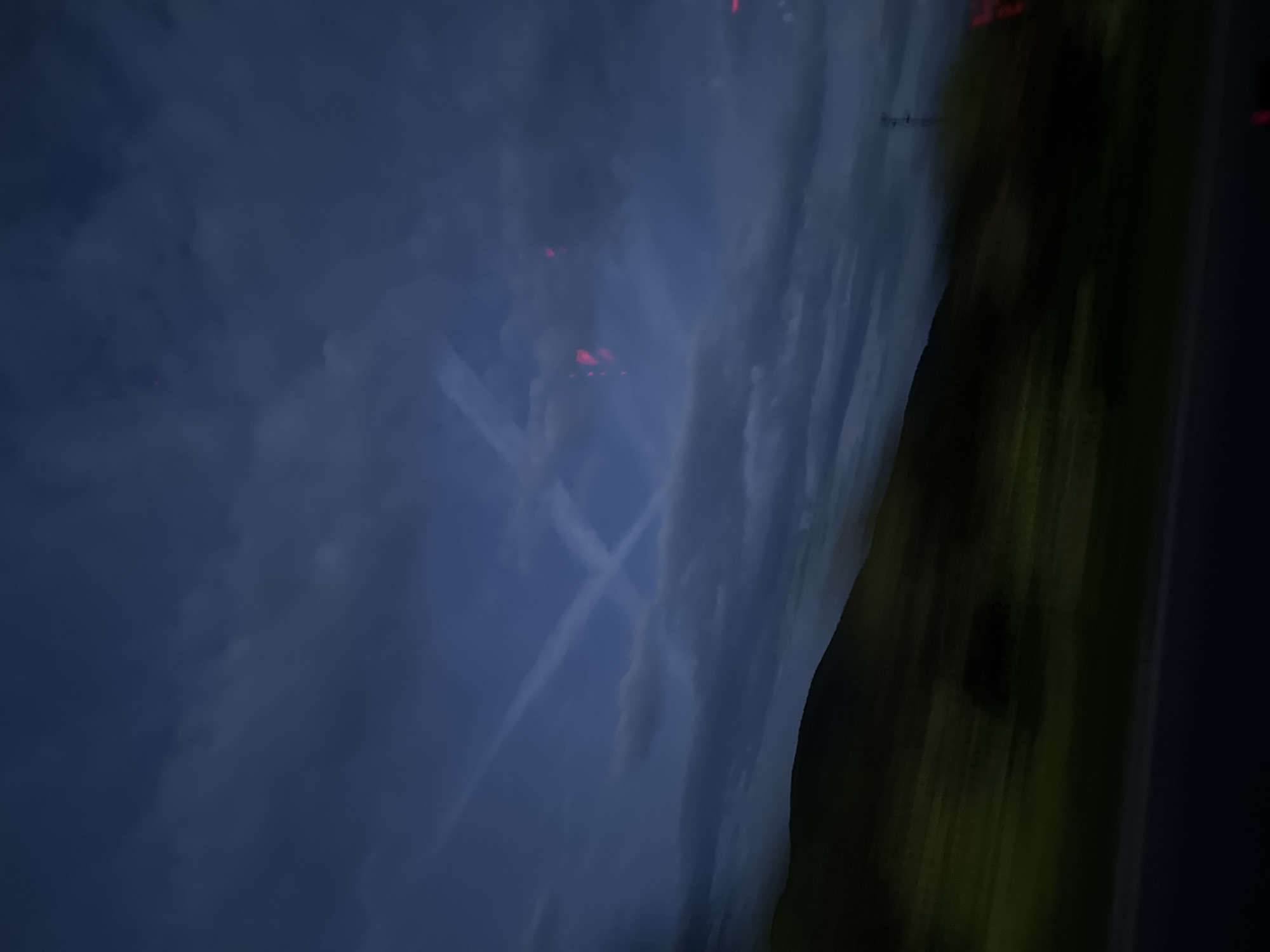 Airplane contrails spotted in twilight sky over Bulgarian village