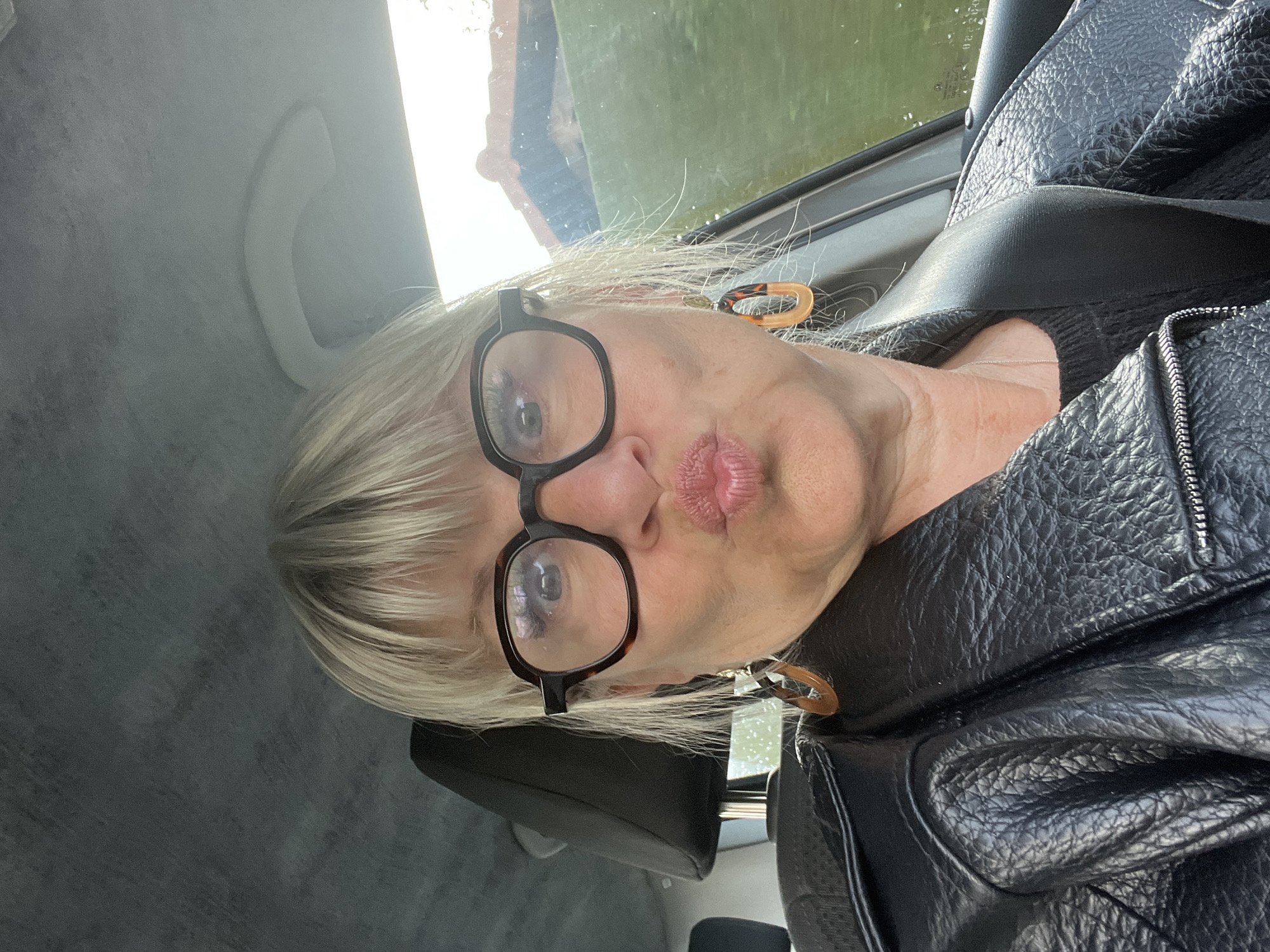 Woman Takes Selfies in Car in French Village