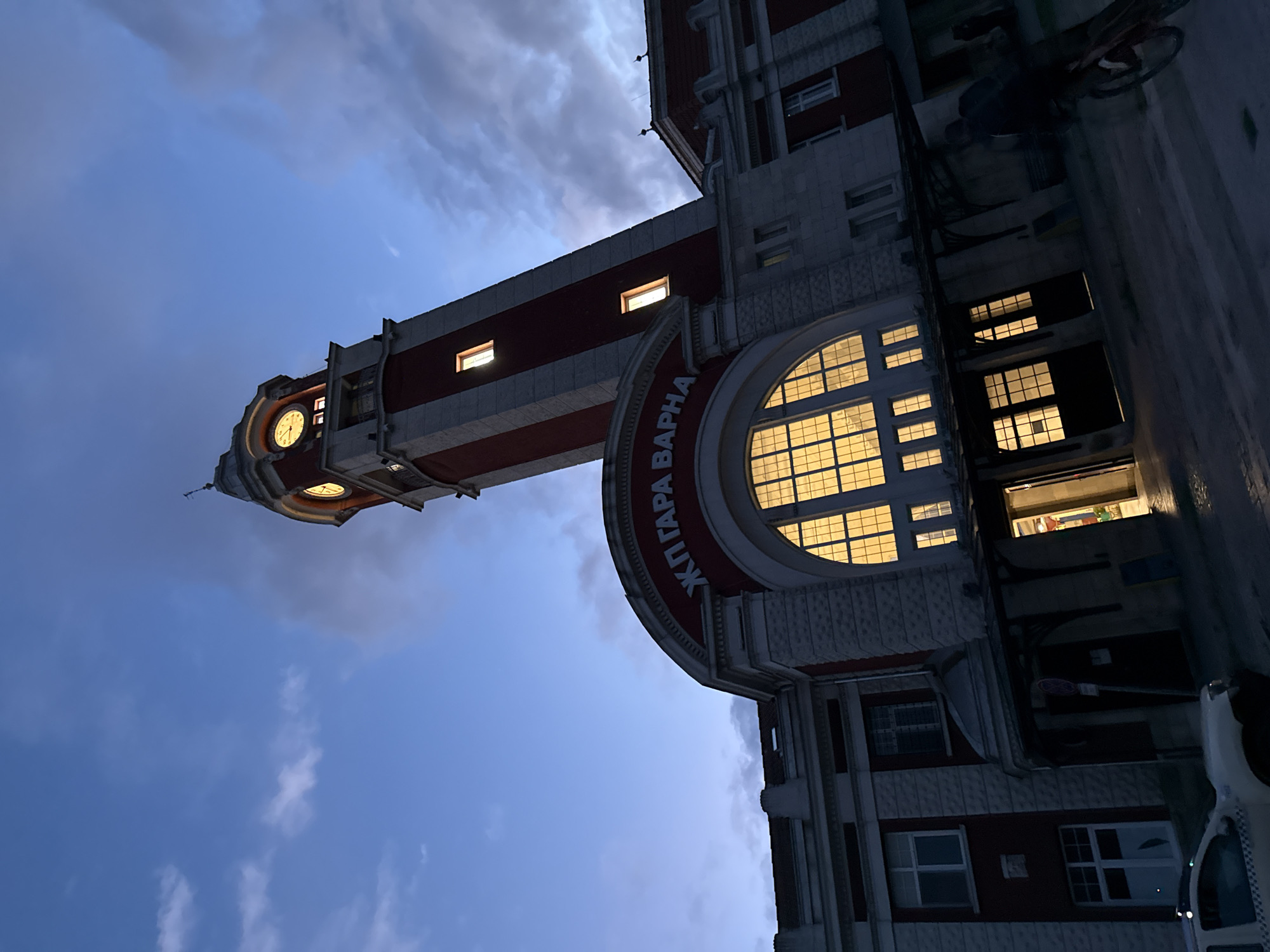 Evening urban scenes captured: clock tower, cityscape, illuminated Ferris wheel