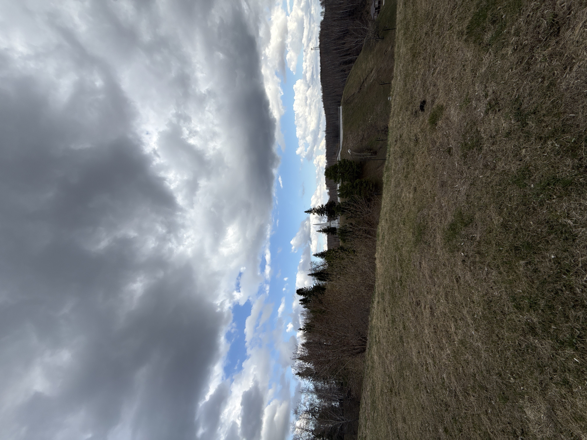 Tourist documents historic Tobolsk Kremlin under cloudy skies