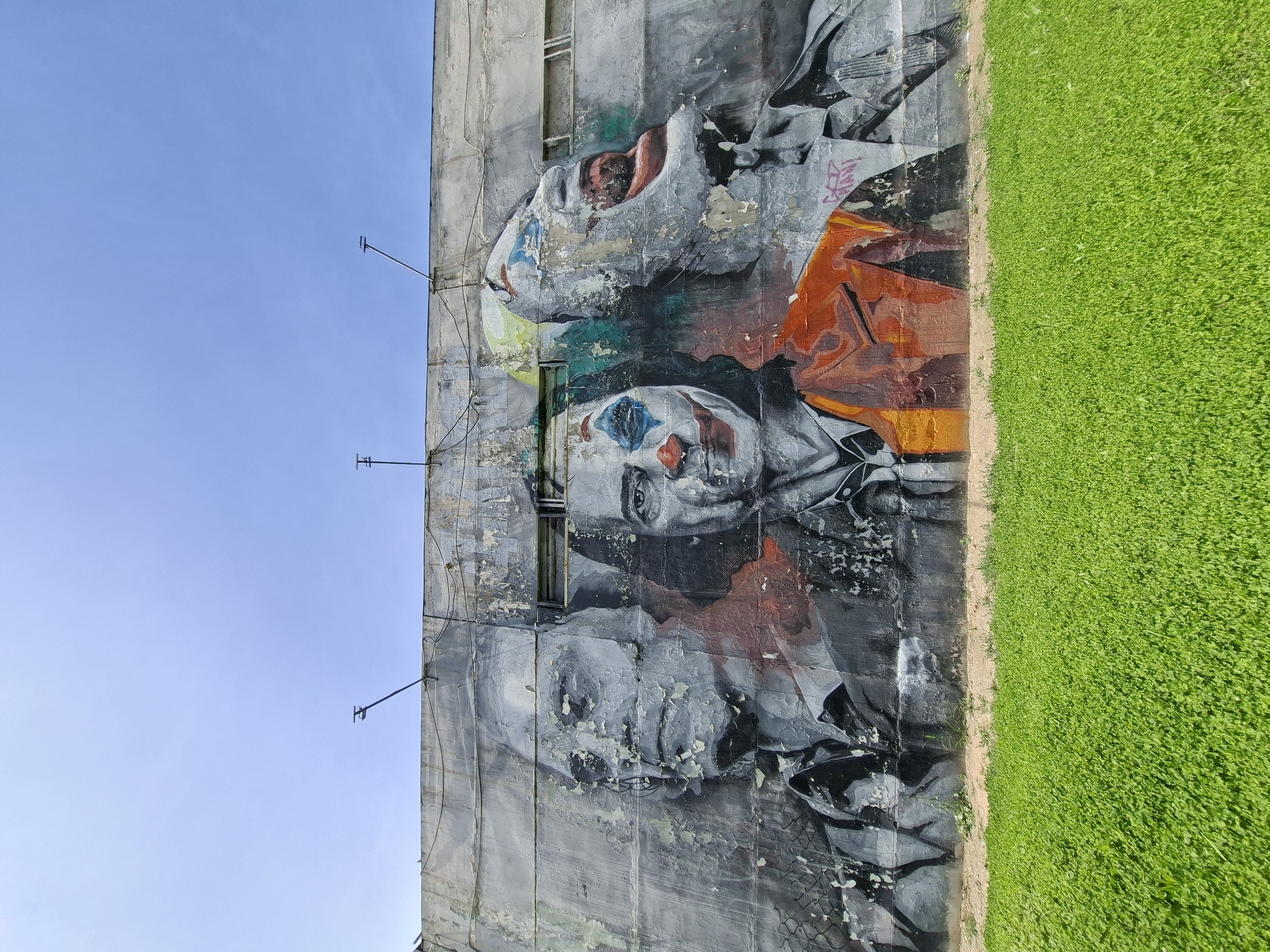 Joker-themed street mural on a weathered Almaty wall