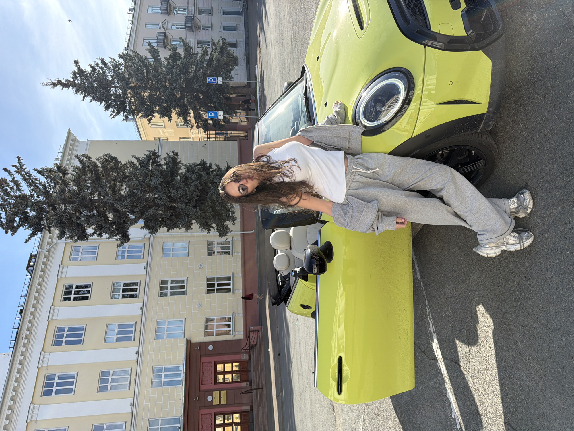 Couple poses with yellow Mini Cooper in Zheleznogorsk
