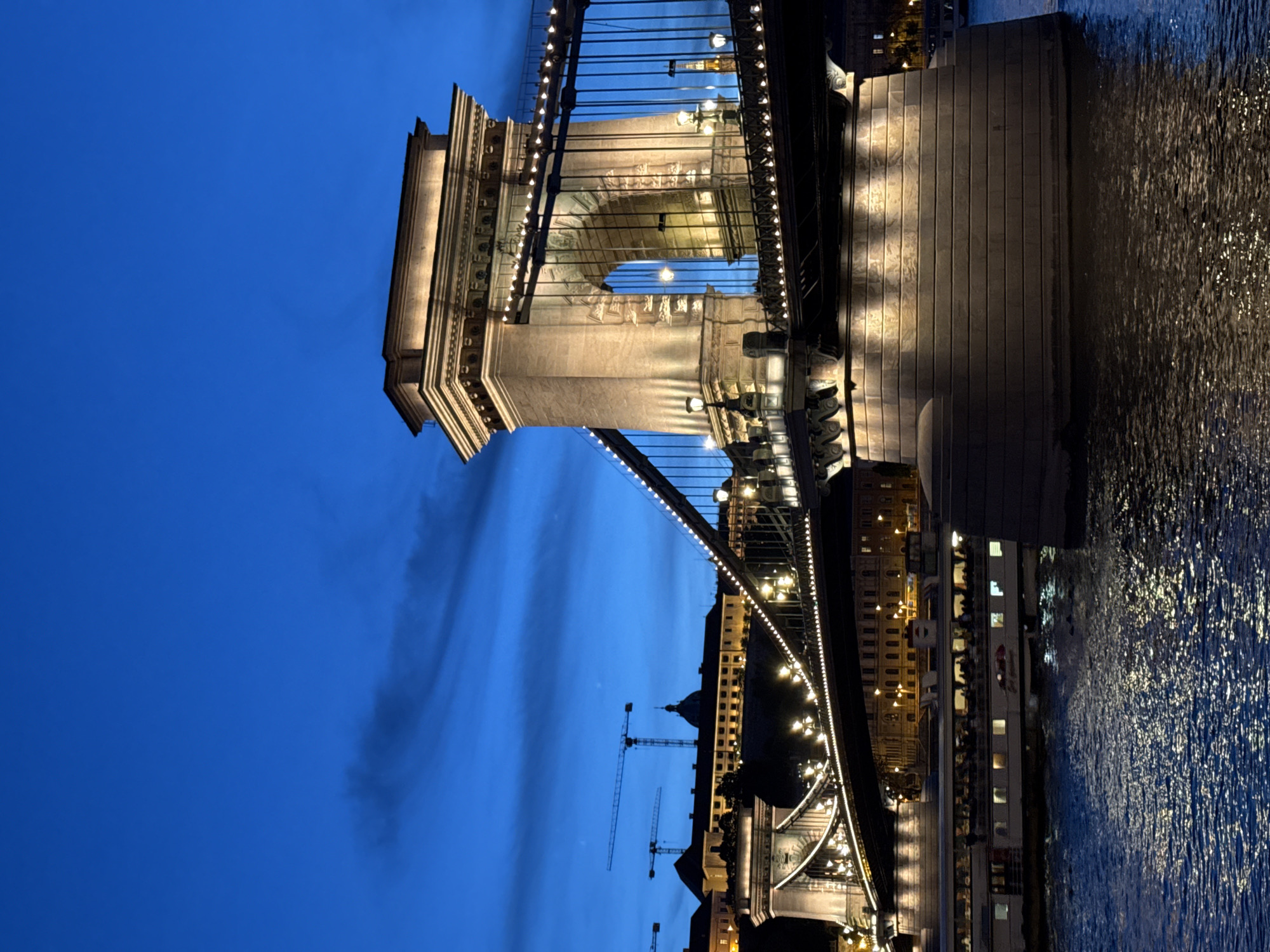 Evening lights illuminate Budapest's Chain Bridge at dusk