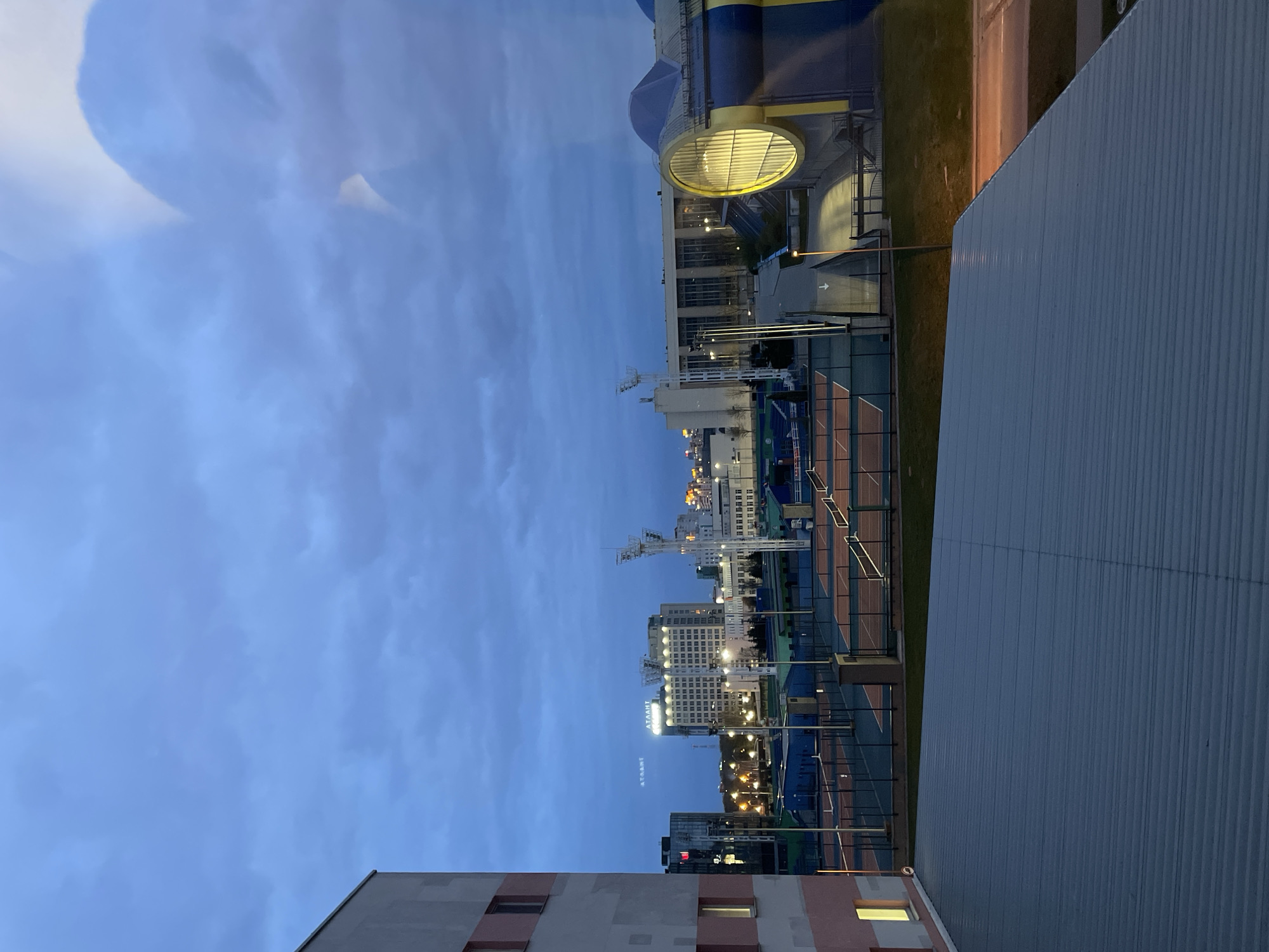 Dusk illuminates Minsk cityscape with tennis courts visible
