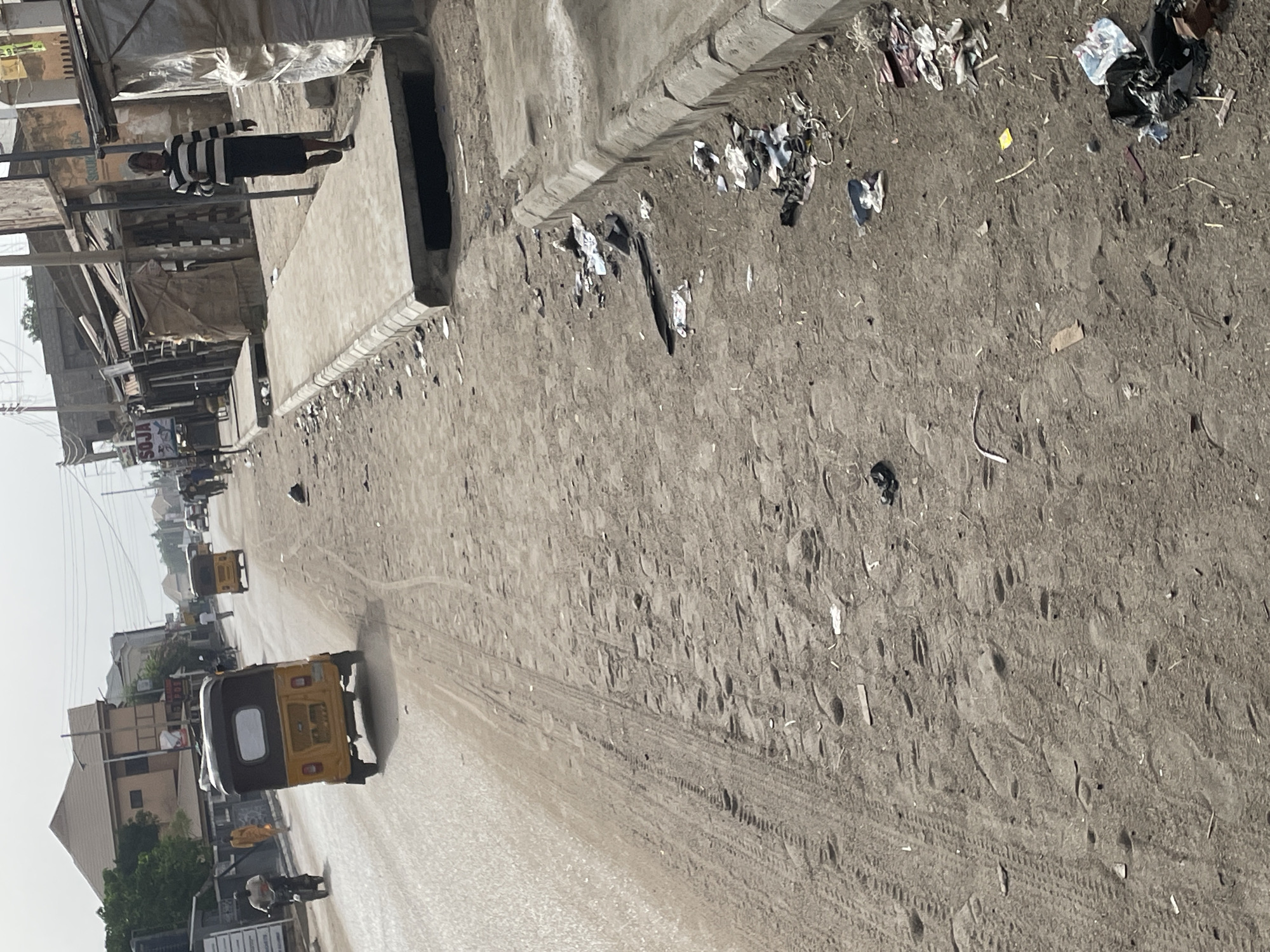 Morning street life documented in unidentified arid urban area