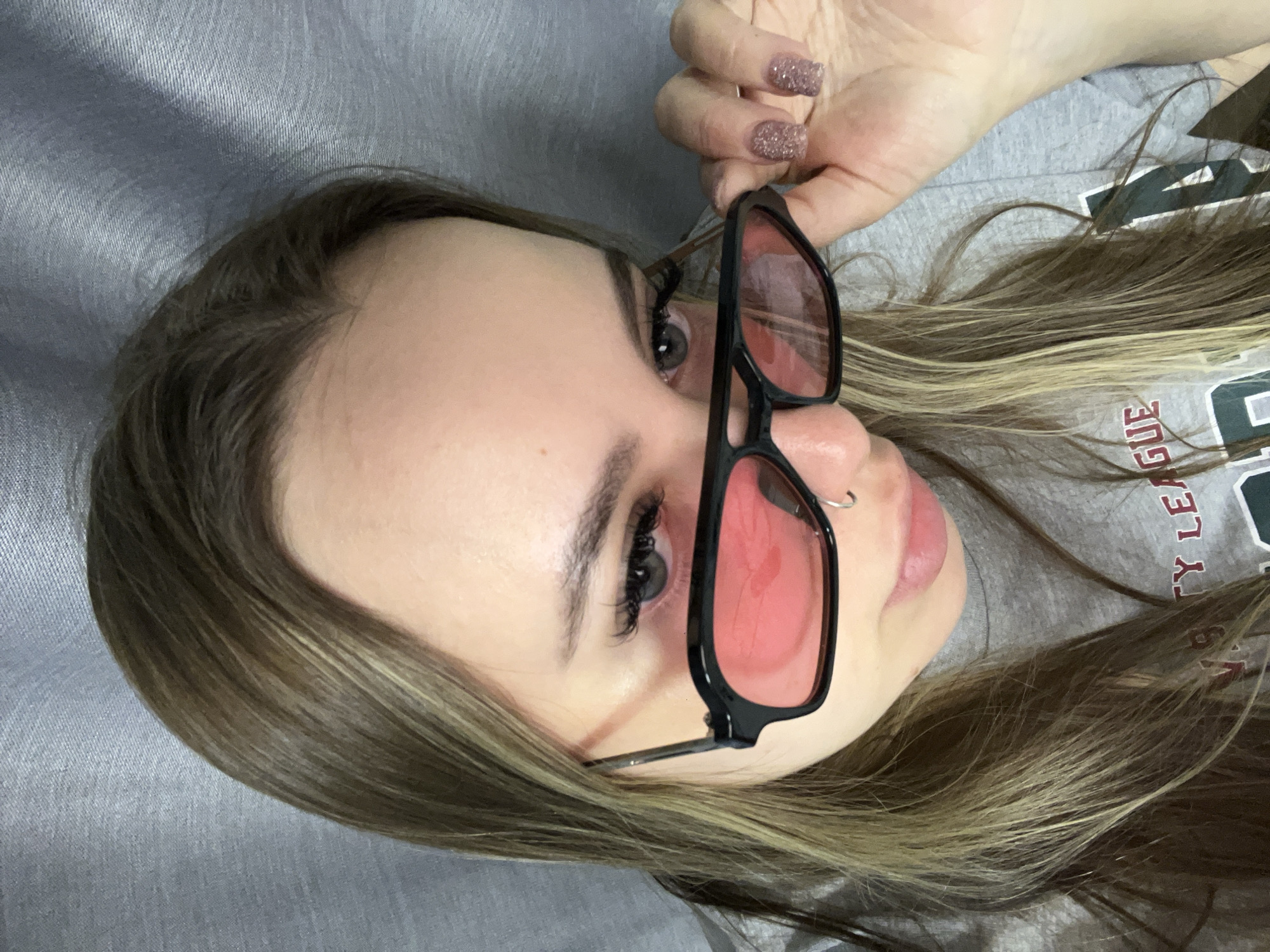 Woman rests with red-tinted glasses in Krasnodar
