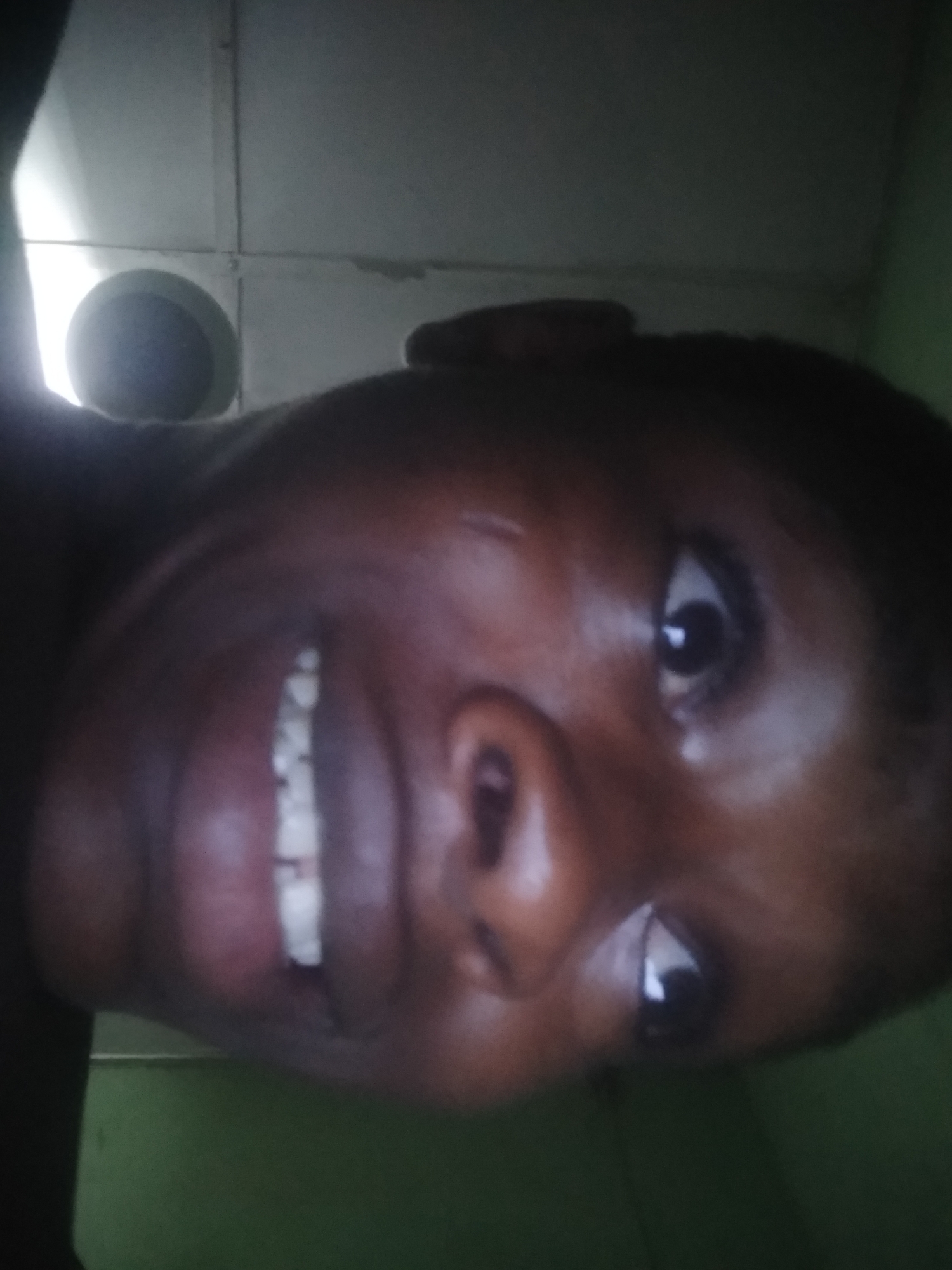 Person photographed multiple times indoors in Shangisha, Nigeria