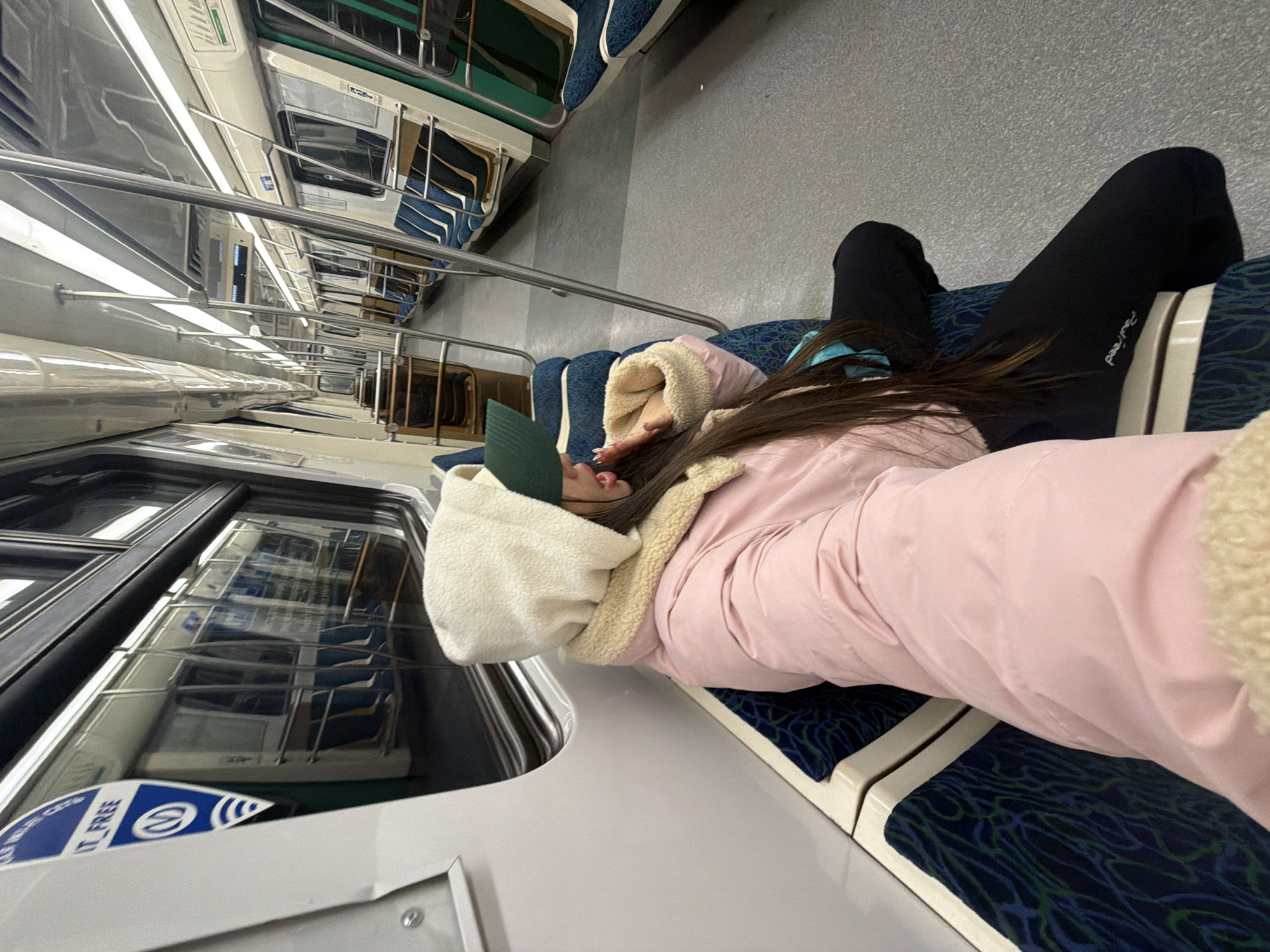 Woman sleeps across metro seats in Saint Petersburg train