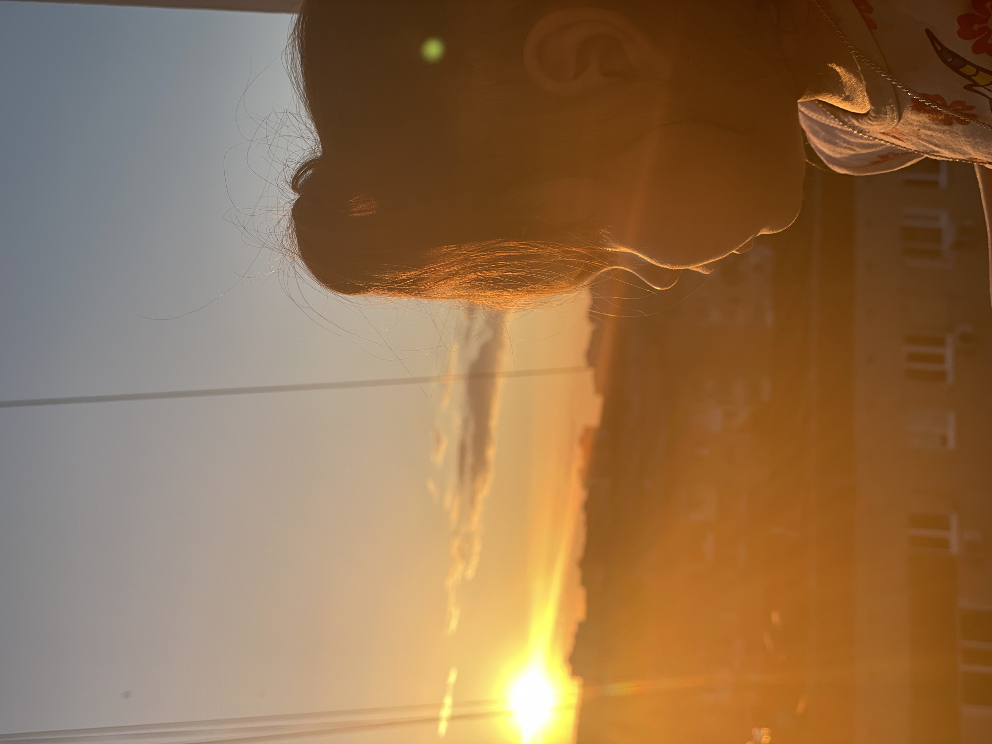 Child watches sunset from balcony in Izhevsk, Russia