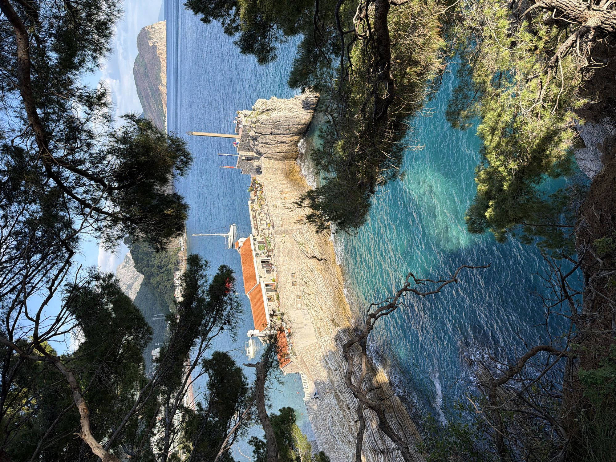 Coastal views and vehicle towing documented in Petrovac, Montenegro