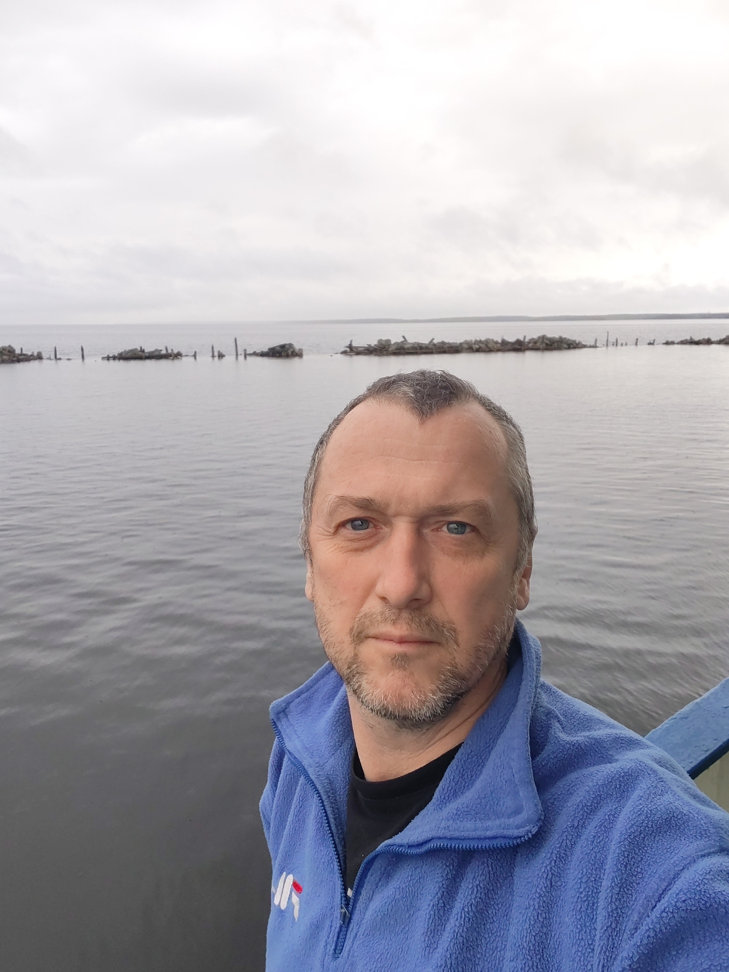 Visitor documents industrial waterfront scenes in Medvezhyegorsk, Russia