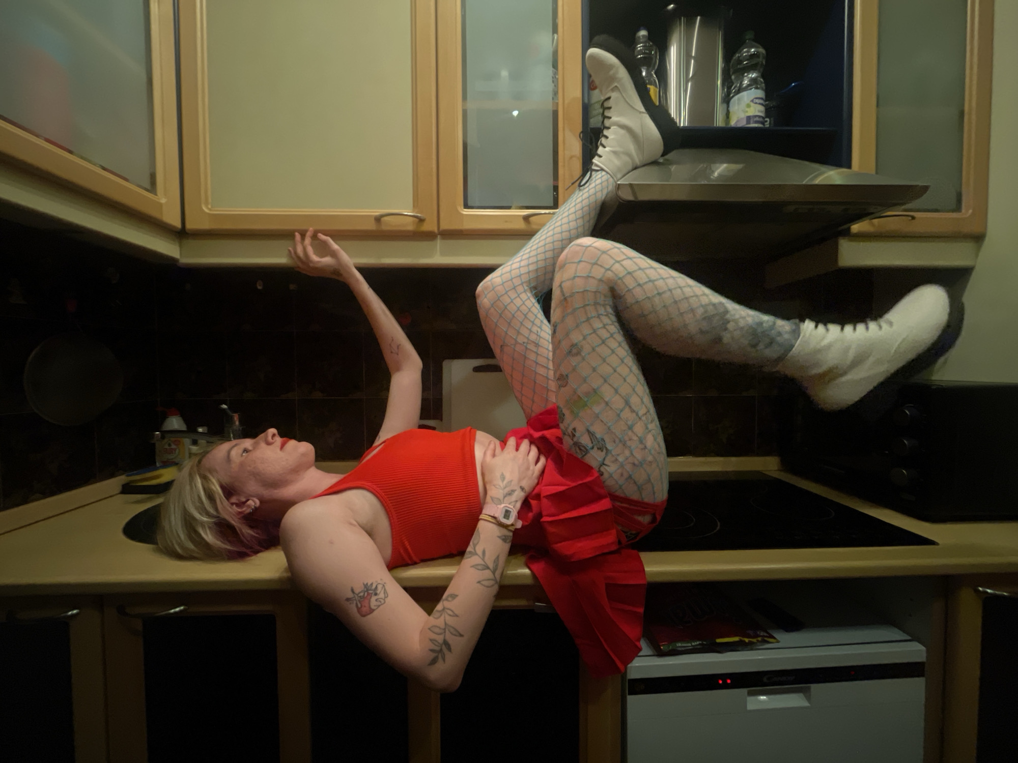 Woman in red dress observed on kitchen counter in Belgrade