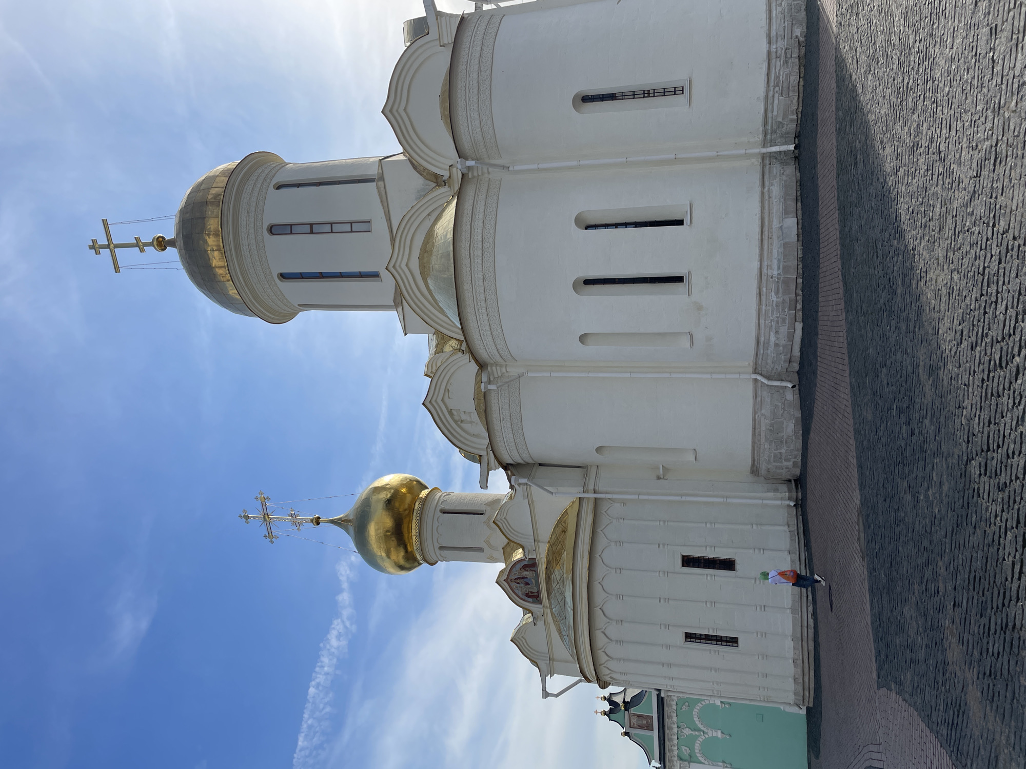 Eastern Orthodox church with gilded domes, ornate exterior detailing.