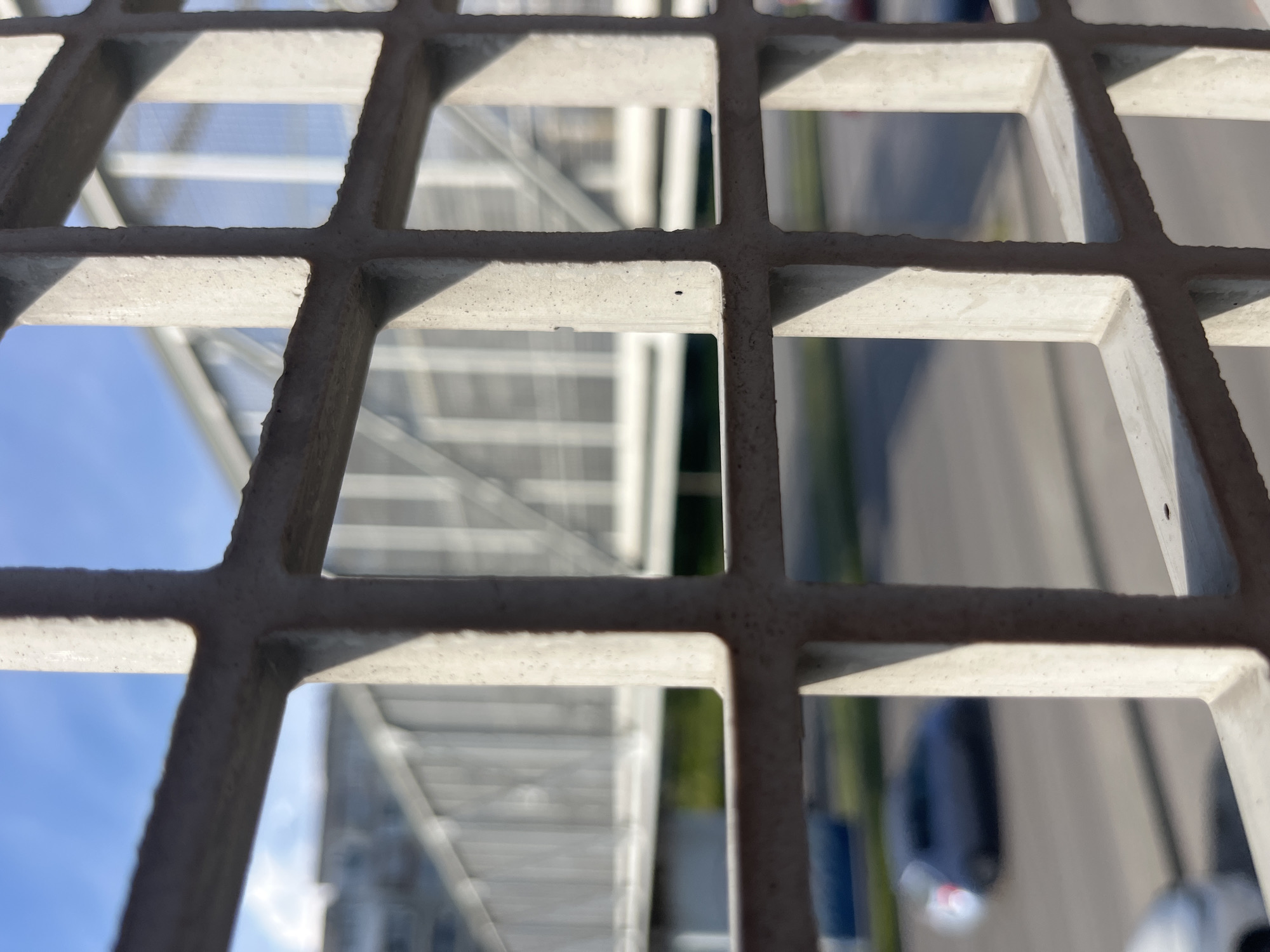 Pedestrian documents urban view through bridge grid in Varna
