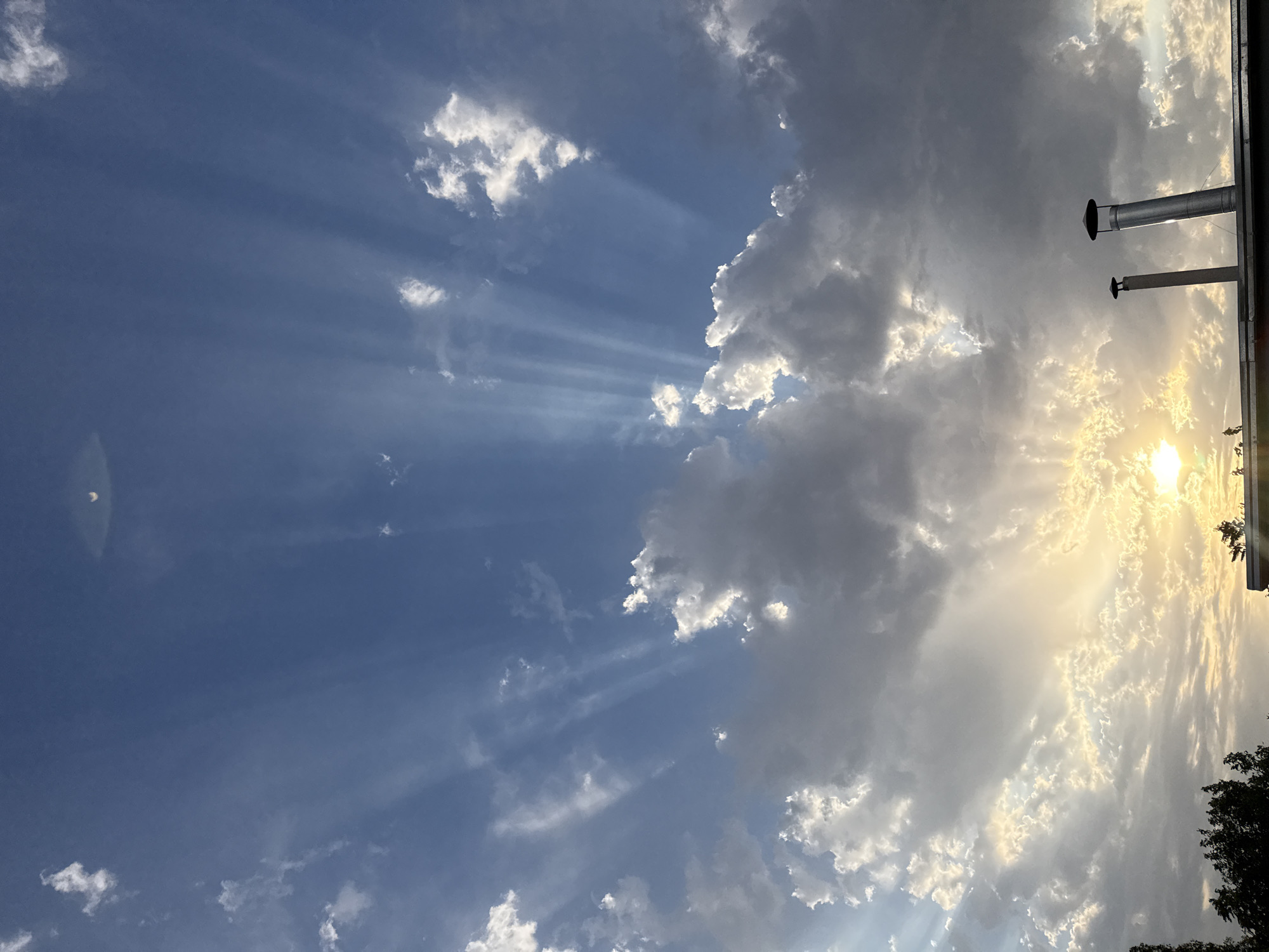 Golden sunbeams pierce through clouds over Yangibazar