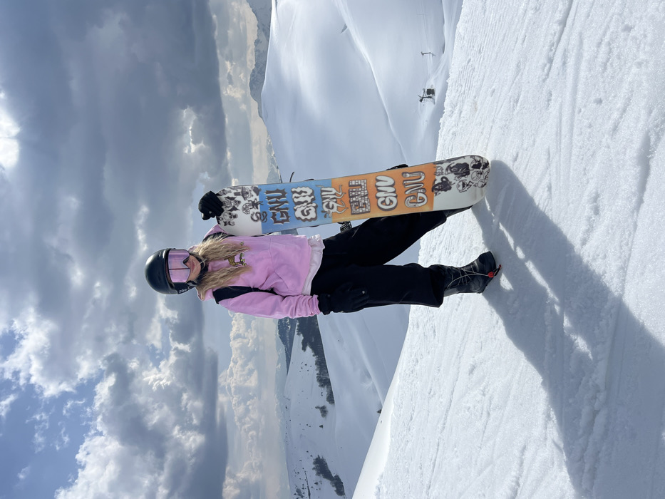 Snowboarder documented at Montenegro ski resort during sunny mountain day