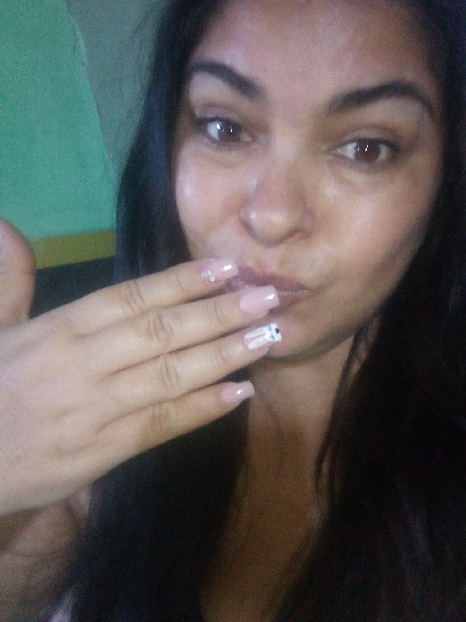 Woman poses with decorative nail art in early morning selfies