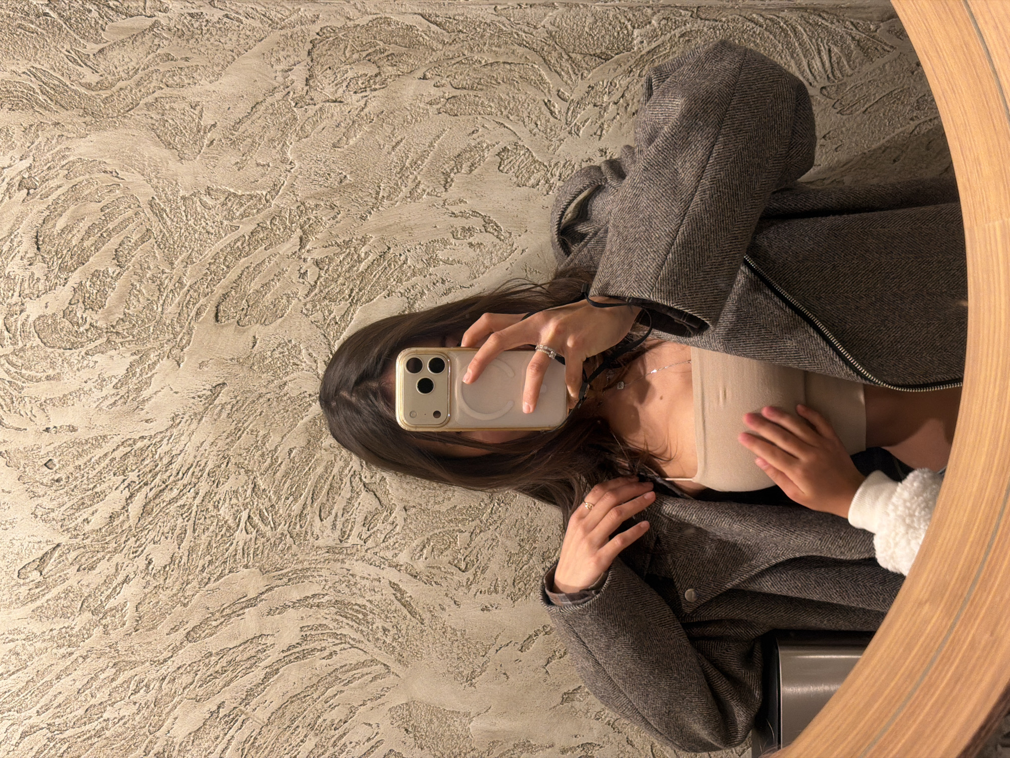Person takes mirror selfie in Krasnoyarsk room