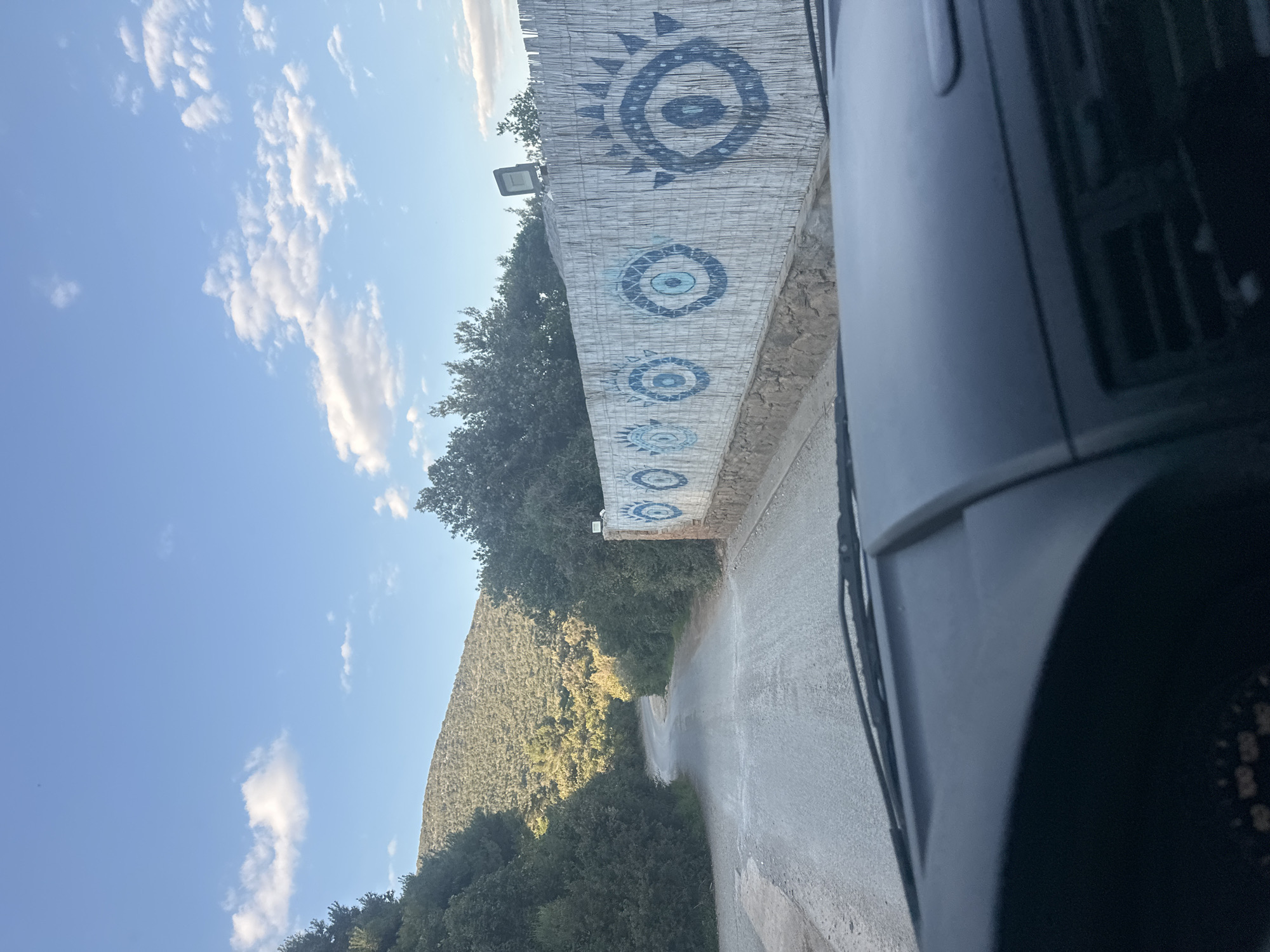 Stone wall with blue eye art spotted in Gošići