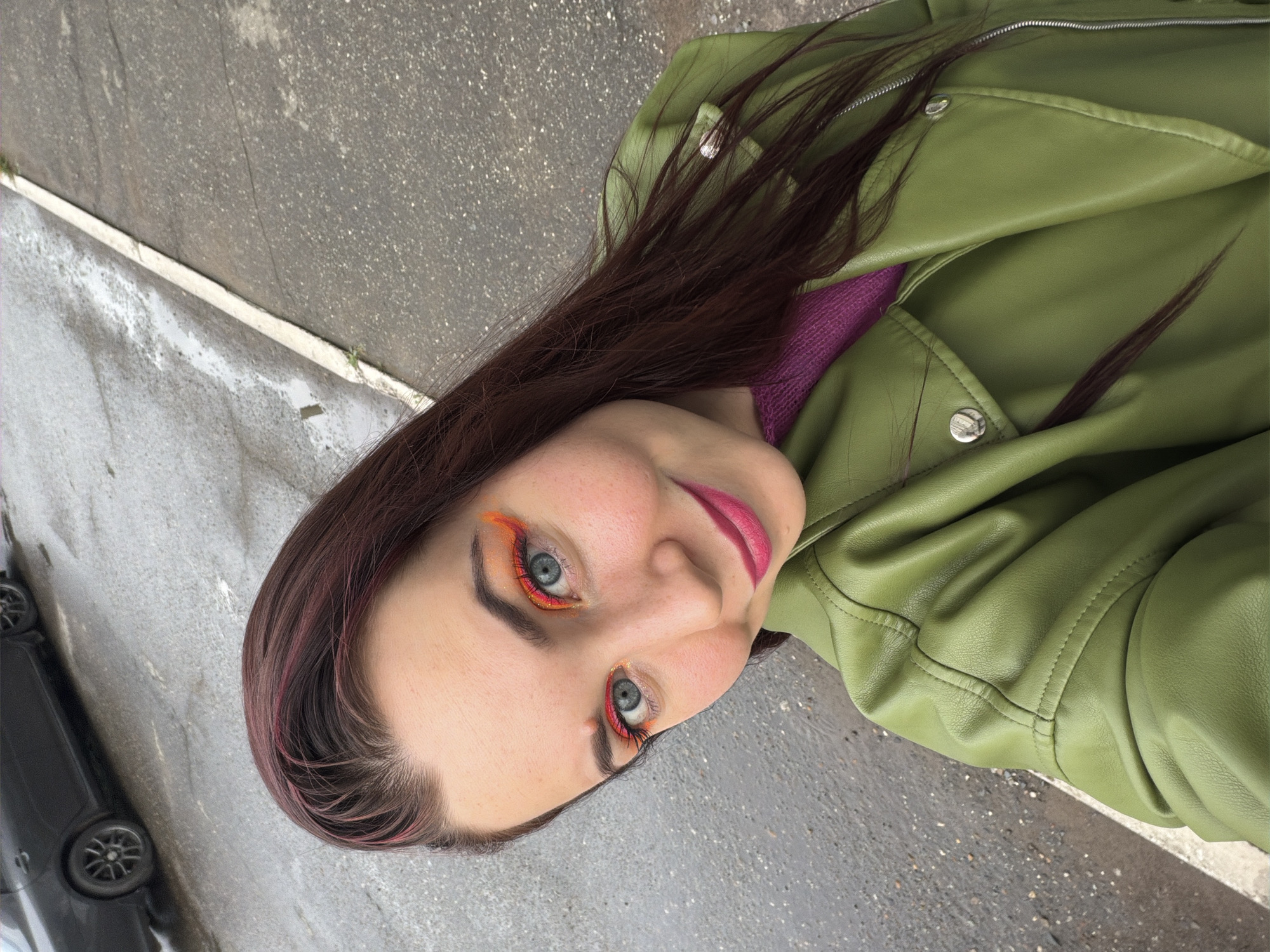 Outdoor selfie with bold makeup and colorful style in Chaikovsky