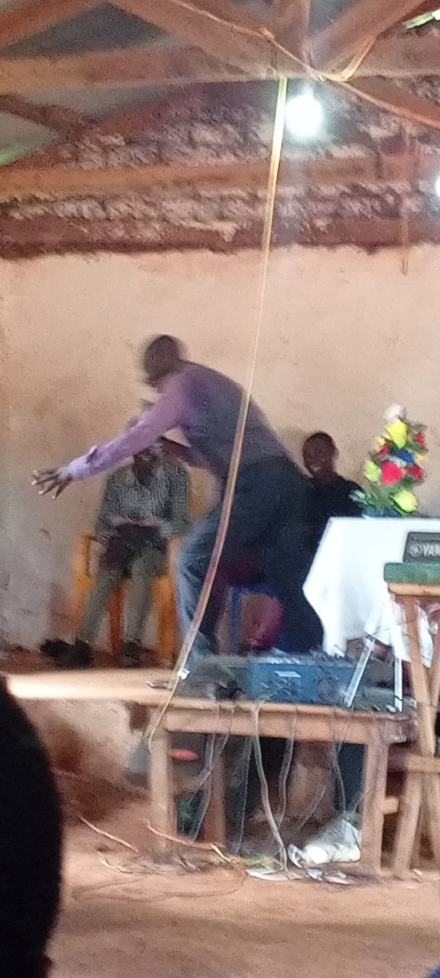 Man delivers speech to audience in Ngalula, DRC