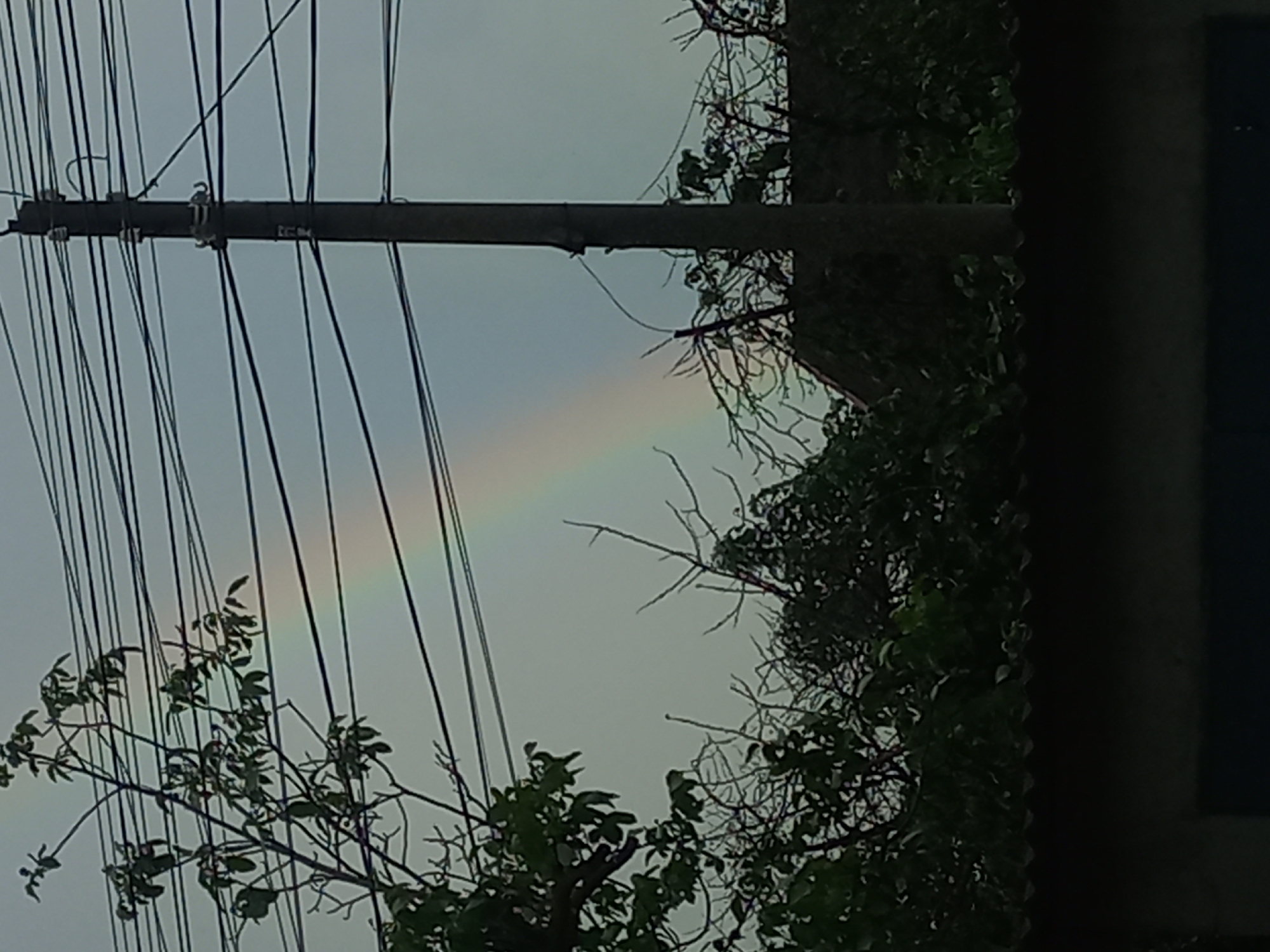 Rainbow and wet streets captured after afternoon rain in Ukraine